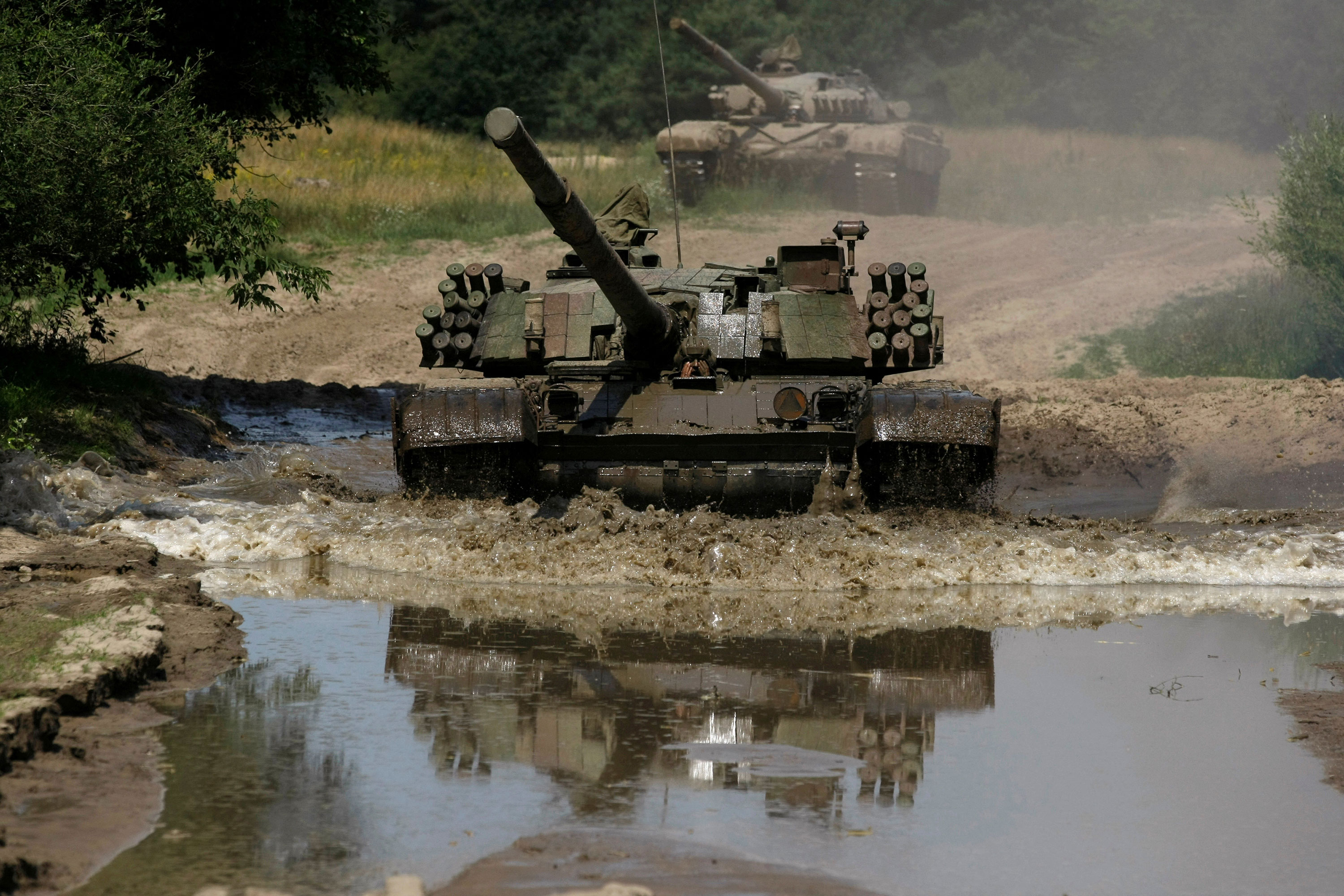 A Polish PT-91 tank drives through water at the military base in Bedrusko near Poznan, western Poland, on July 9, 2013. 