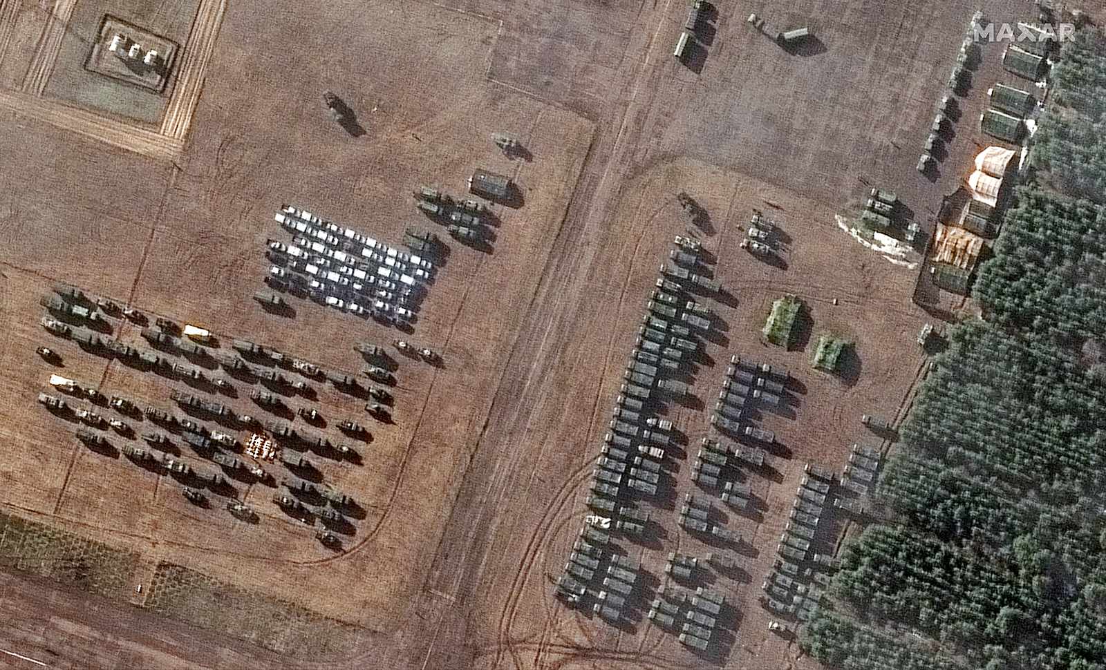 Satellite images show dozens of tents and vehicles that have appeared in recent days at an airfield southwest of Mazyr in southern Belarus.