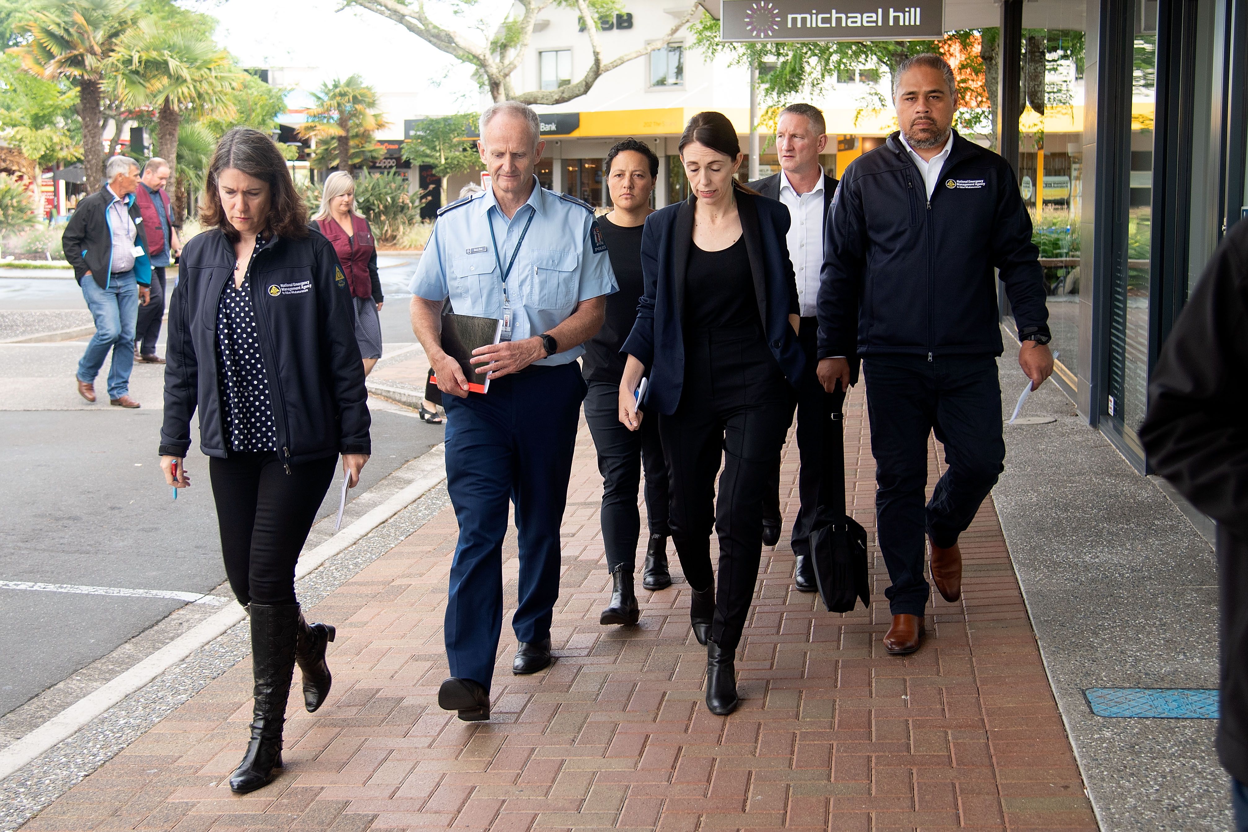 New Zealand Prime Minister Jacinda Ardern with other officials in Whakatane on December 10.