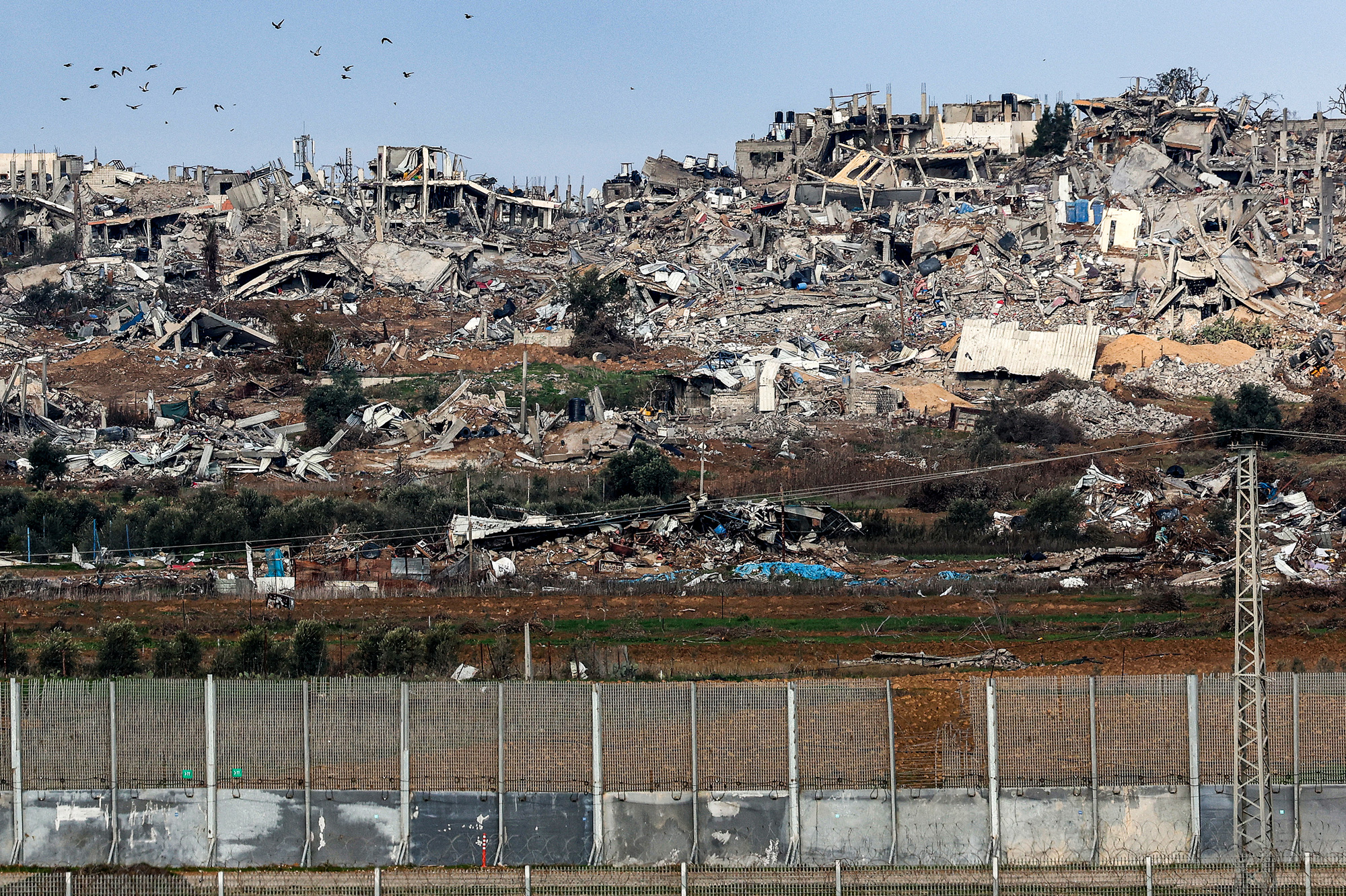 Buildings destroyed by Israeli bombardment in central Gaza, seen across the border in southern Israel, on January 3.