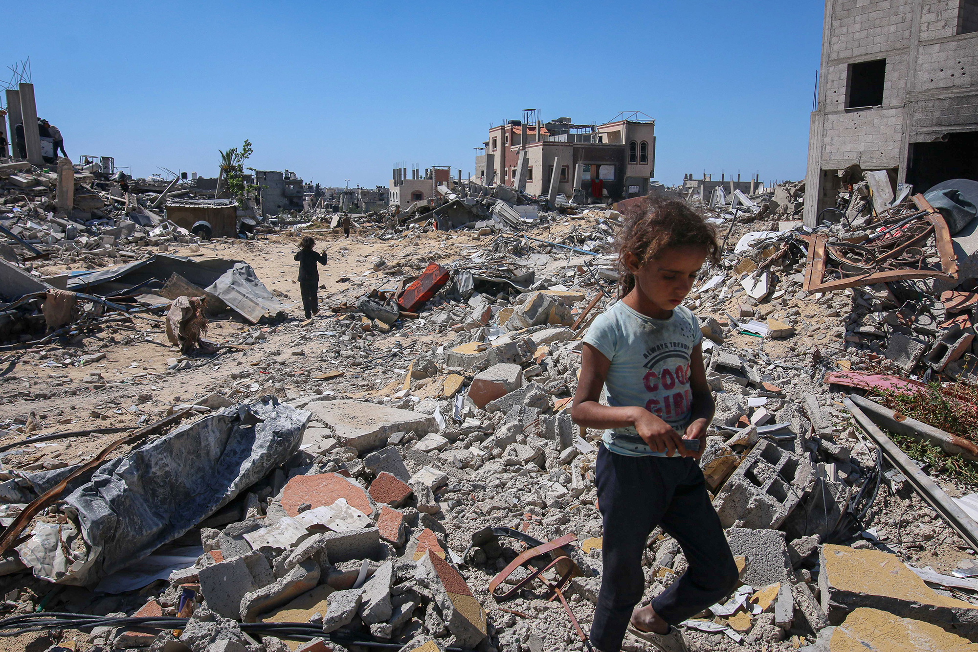 Displaced Palestinians inspect their destroyed homes in Khan Younis, Gaza, after fleeing from Rafah on May 7.