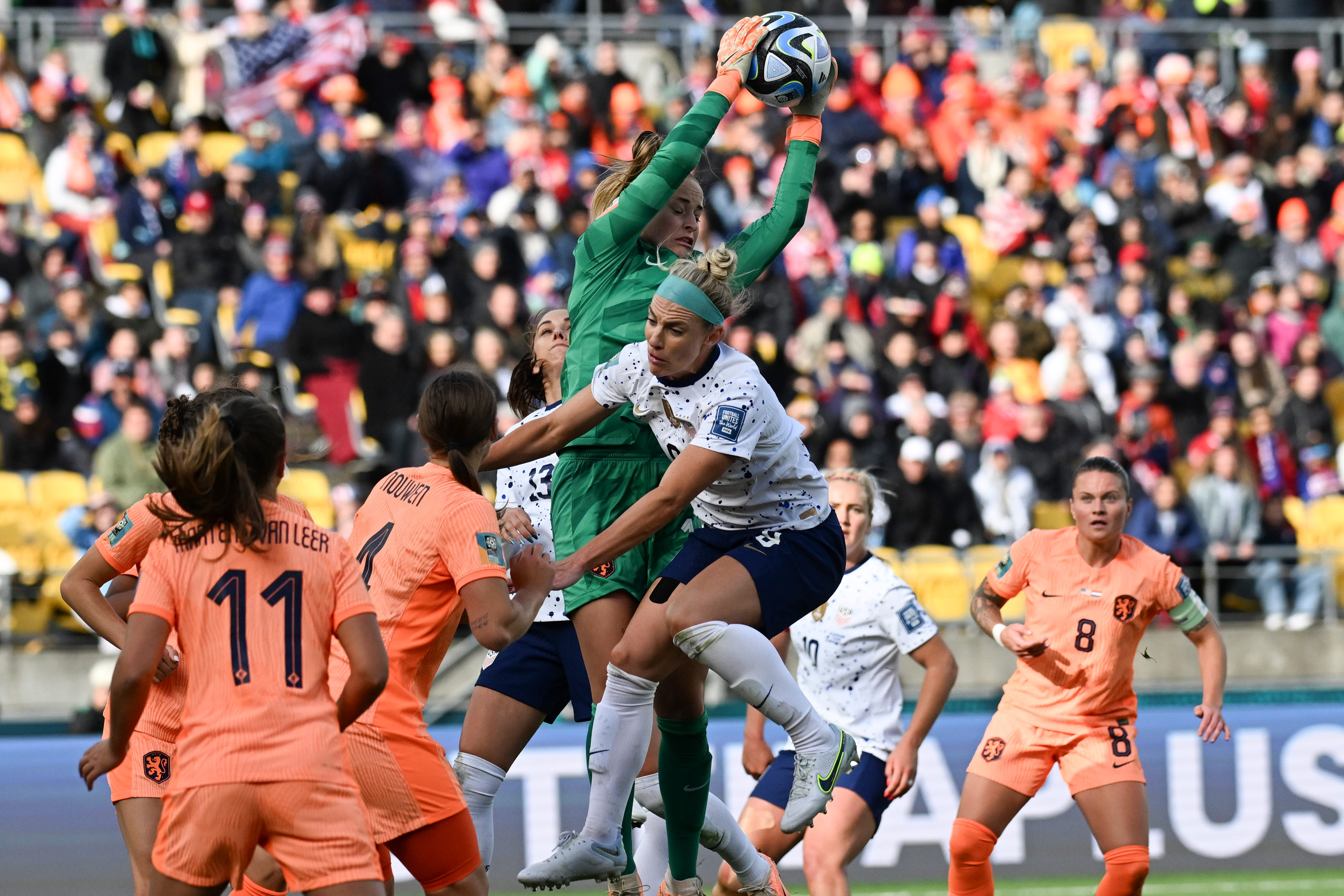 Netherlands' goalkeeper Daphne Van Domselaar takes the ball as USA's Savannah DeMelo collides during the match.