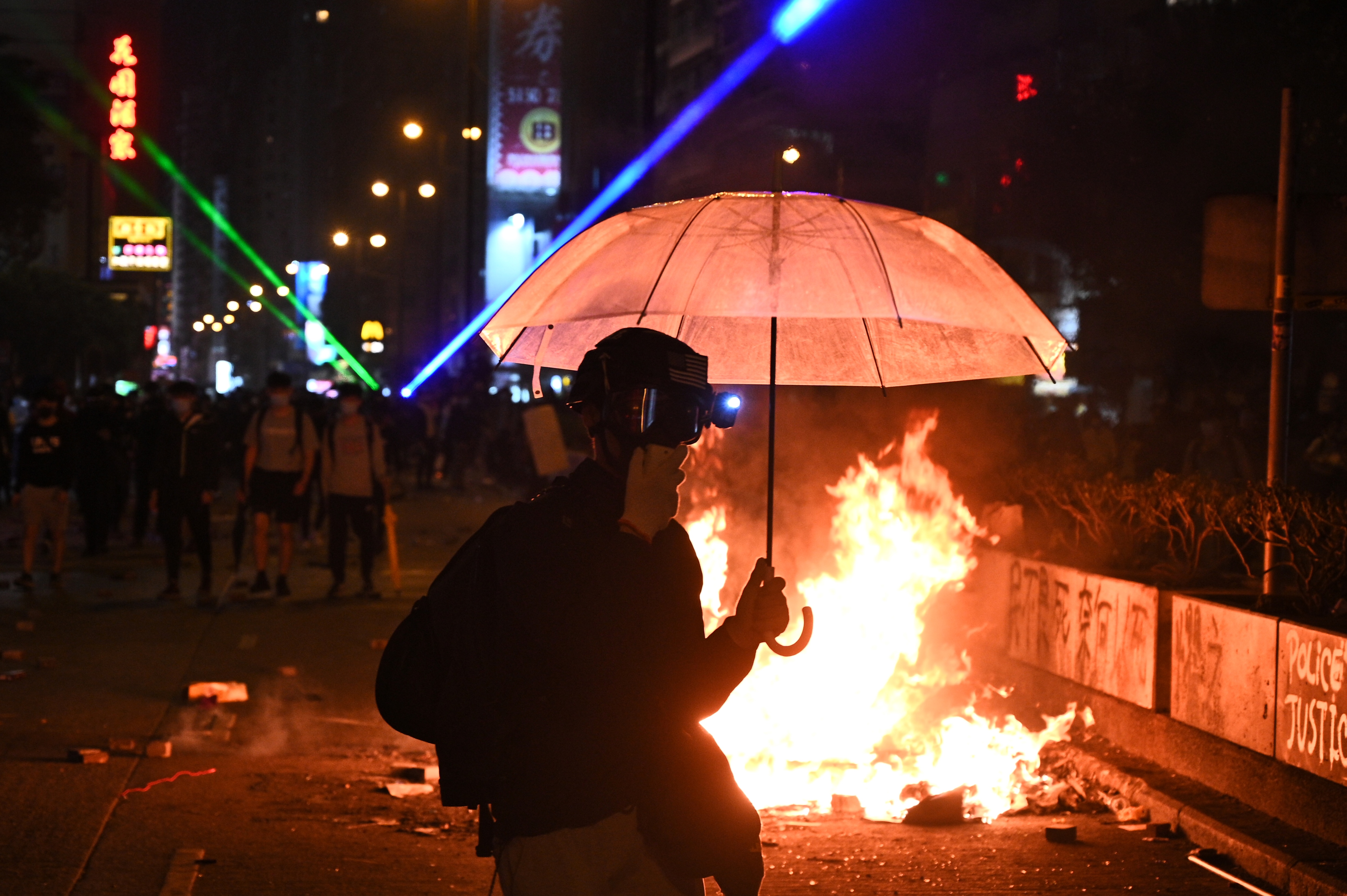 Protesters set a fire as they march to Hong Kong Polytechnic University in Hong Kong on Monday.