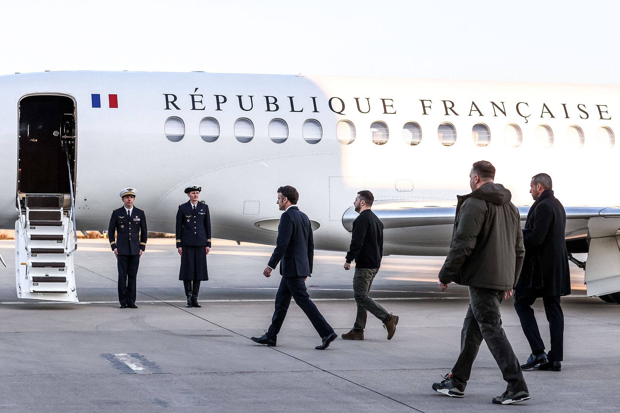 Macron and Zelensky walk on the tarmac of Velizy-Villacoublay airbase as they prepare to board a flight together, en route to Brussels for a summit at the EU parliament, on February 9.