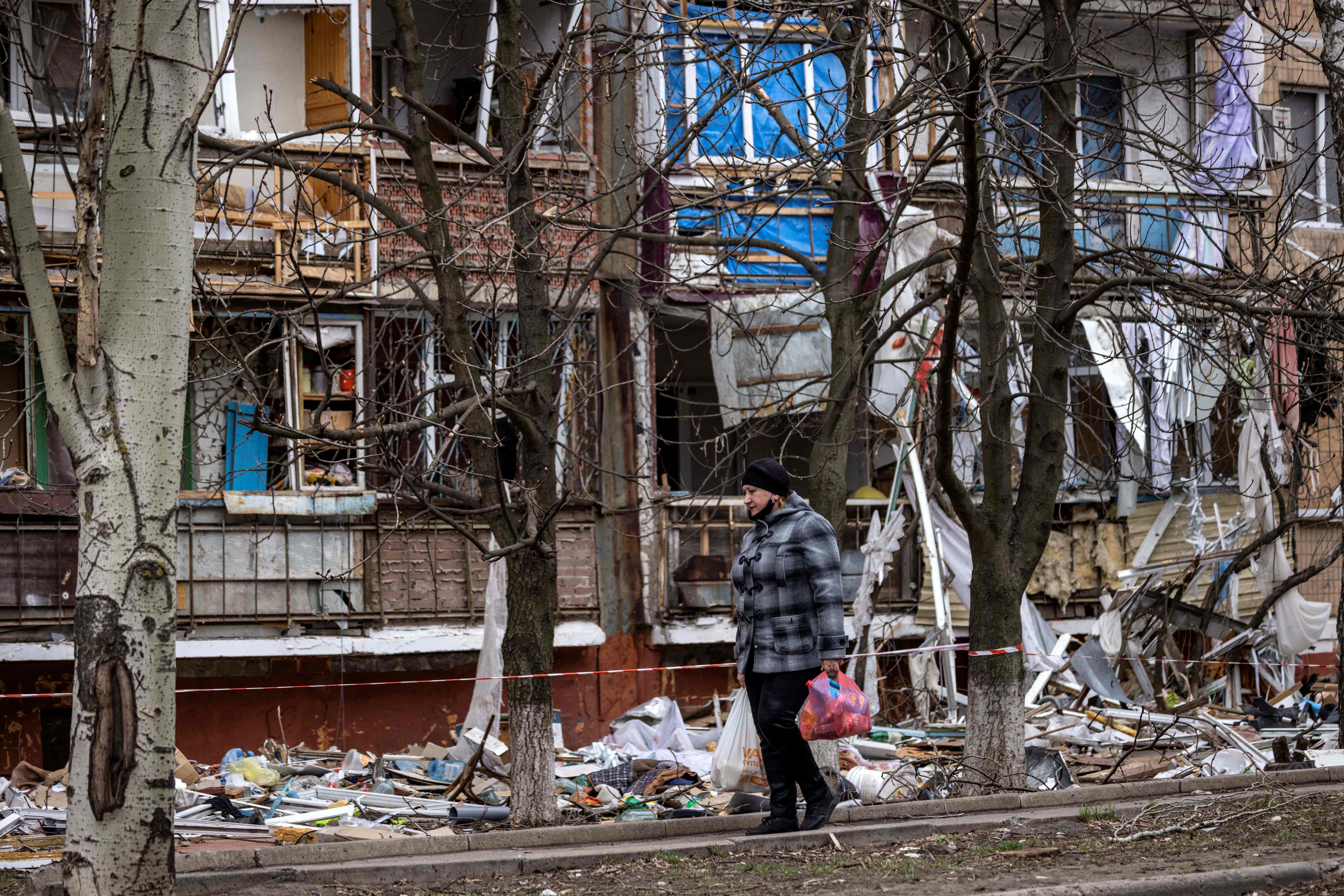 A woman walks near a damaged building in the eastern city of Kramatorsk, in the Donbas region of Ukraine, on April 3.