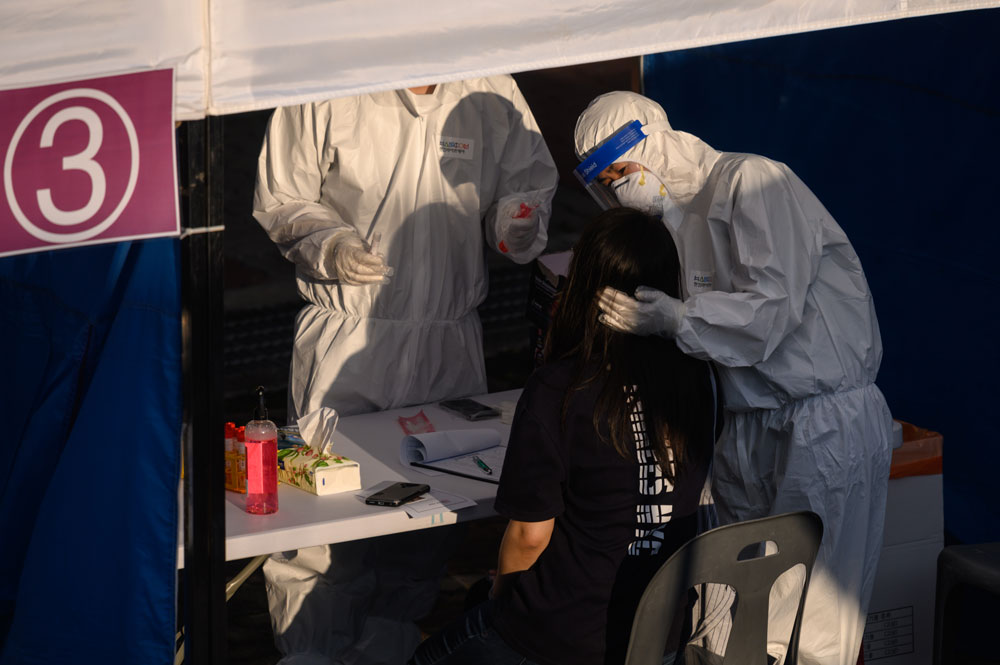 A health worker administers a swab at a testing center in Bucheon, south of Seoul, on May 27.