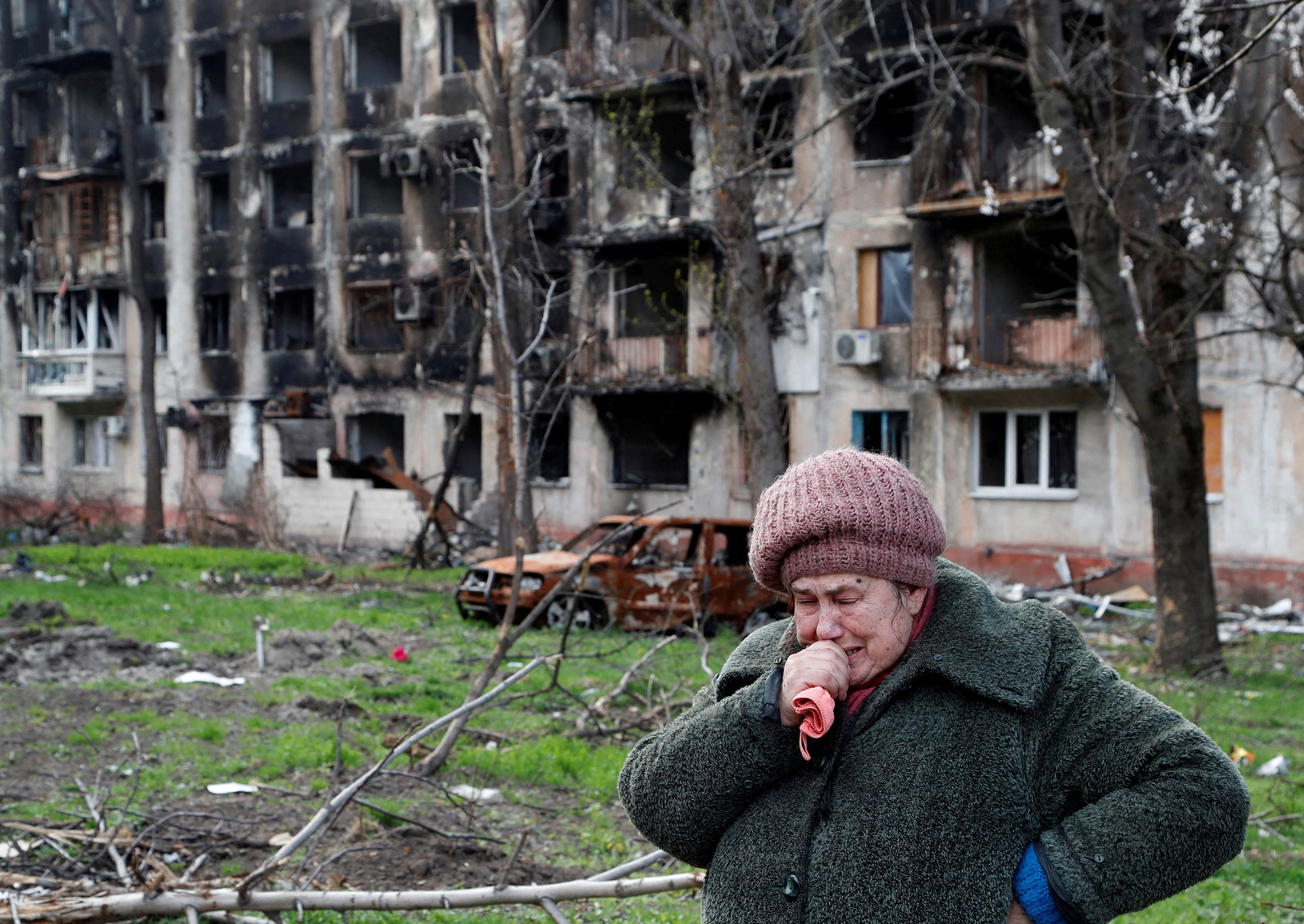 Local resident Tamara, 71, cries in front of a destroyed apartment building in Mariupol, on Tuesday.