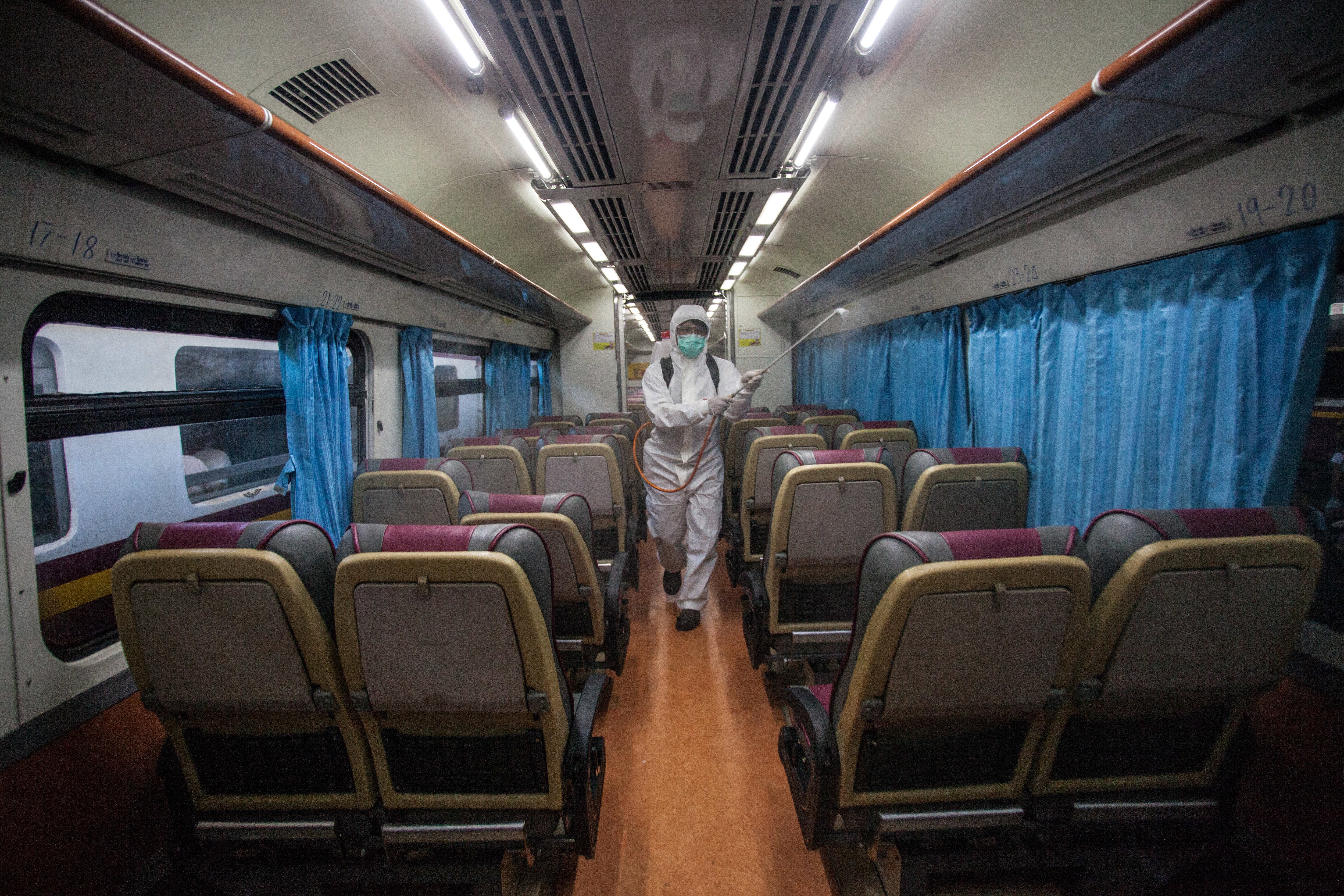 A worker disinfects a train at Hua Lamphong Railway Station in Bangkok on Wednesday, March 4.