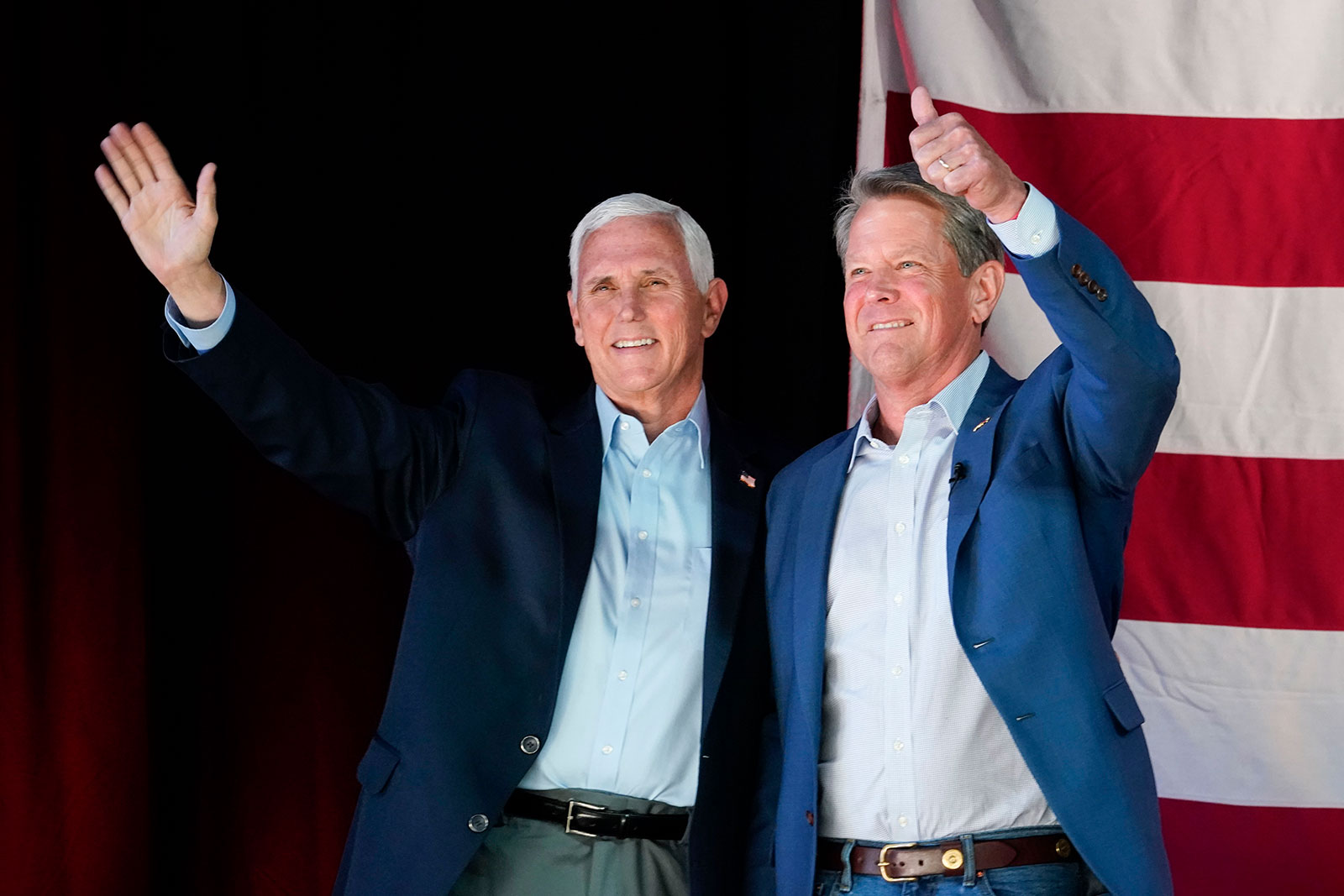 Former Vice President Mike Pence, left, and Georgia Gov. Brian Kemp, right, greet the crowd during a Get Out the Vote Rally, on Monday, May 23. 