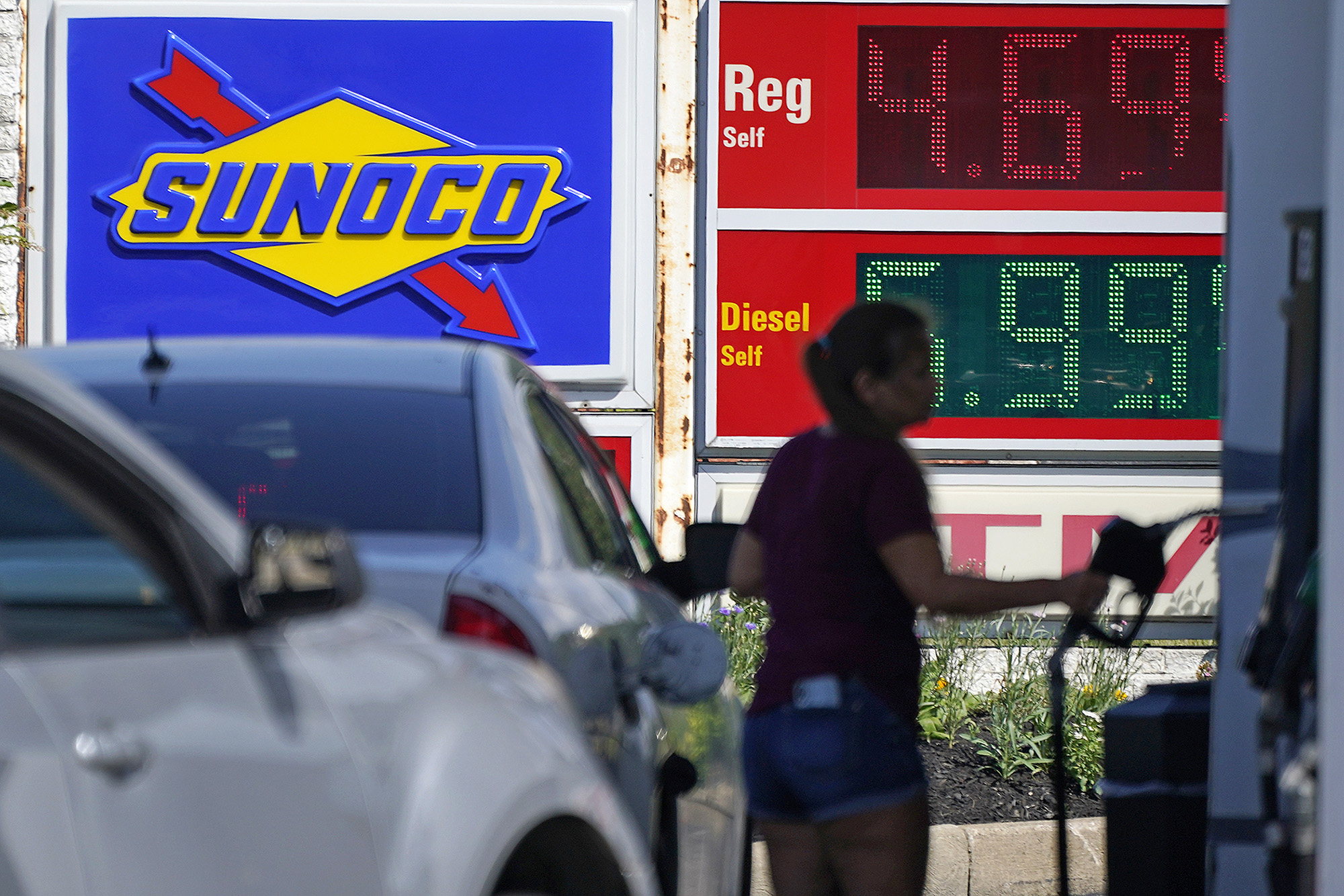 A woman pumps gas at a Sunoco mini-mart in Independence, Ohio, on July 12.