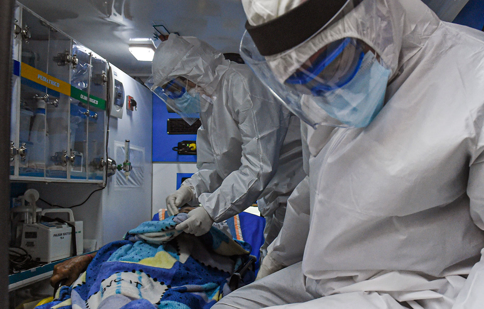Healthcare workers transfer a coronavirus patient to a hospital in Medellín, Colombia, on August 3.