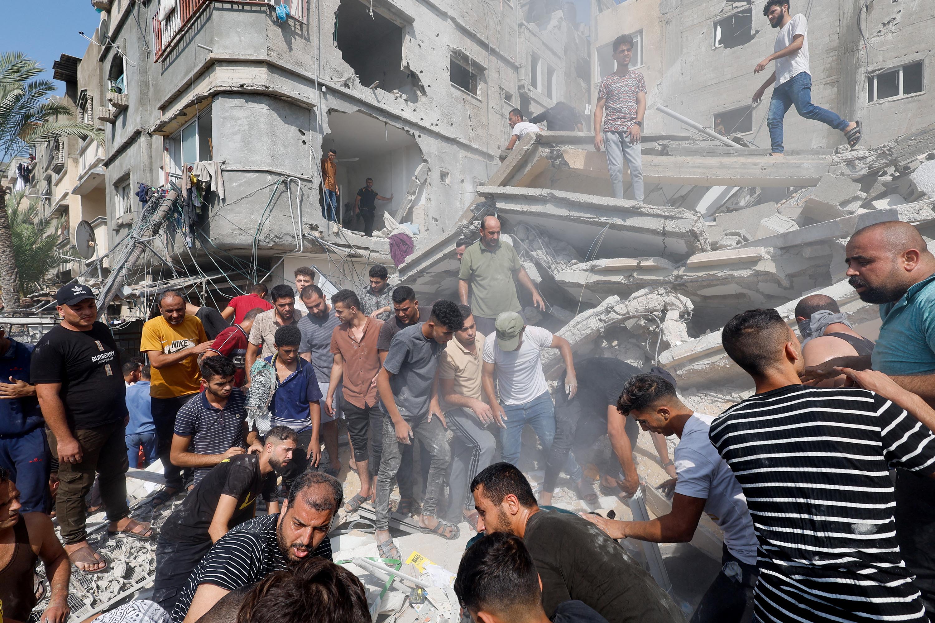 Palestinians gather at the site of an Israeli strike on a house in Khan Younis, Gaza, on October 24. 