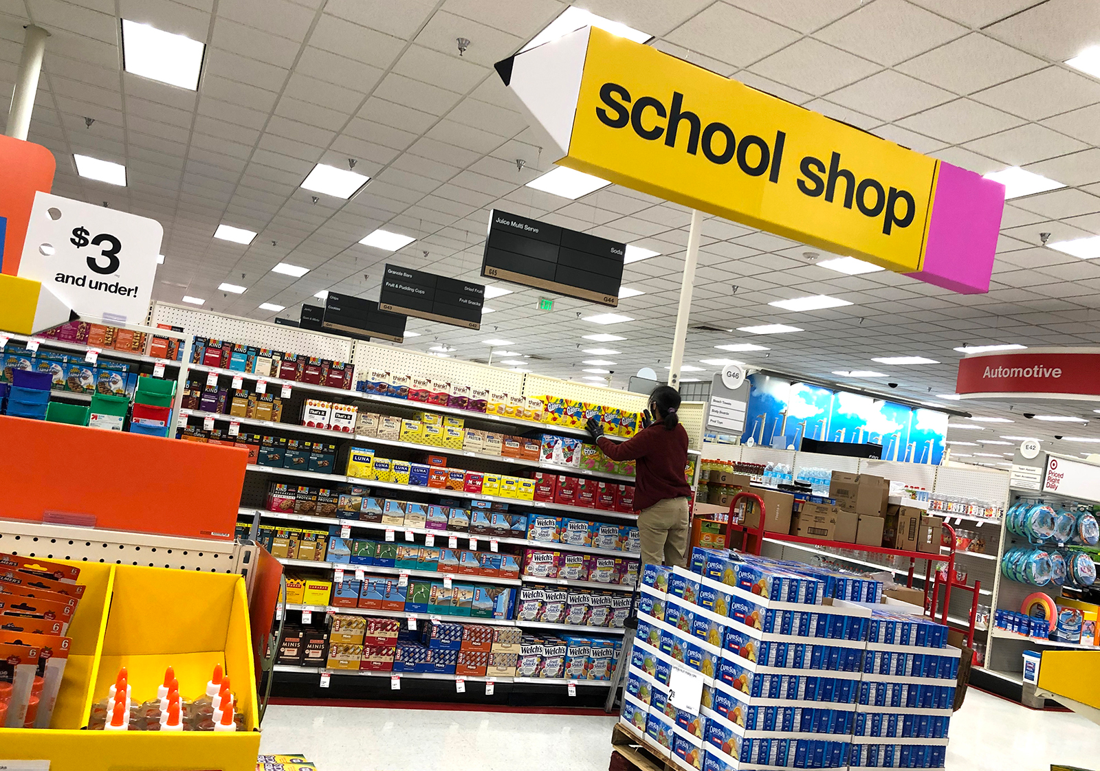 A worker stocks shelves of back-to-school supplies at a Target store on August 3, in Colma, California. In the midst of the ongoing coronavirus pandemic, back-to-school shopping has mostly moved to online sales, with purchases shifting from clothing to laptop computers and home schooling supplies.