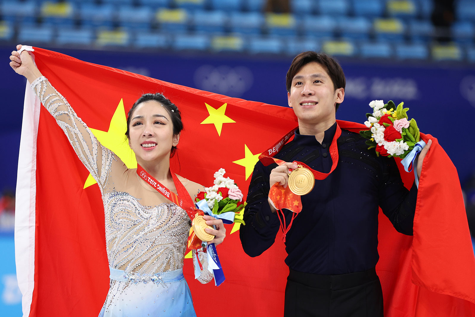 Chinese skating duo Sui Wenjing and Han Cong pose during the medal ceremony following the pairs free skating event on February 19.