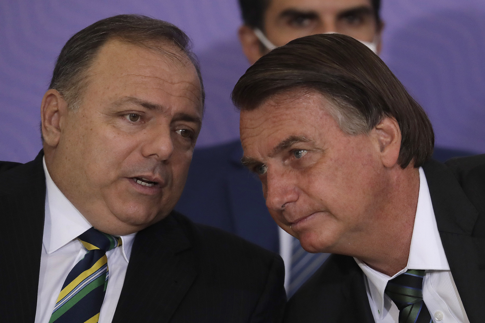 Brazilan President Jair Bolsonaro, right, talks with his Health Minister Eduardo Pazuello during a ceremony presenting Brazil's National Vaccination Plan Against Covid-19 at Planalto presidential palace in Brasilia, Brazil, on Wednesday, December 16.