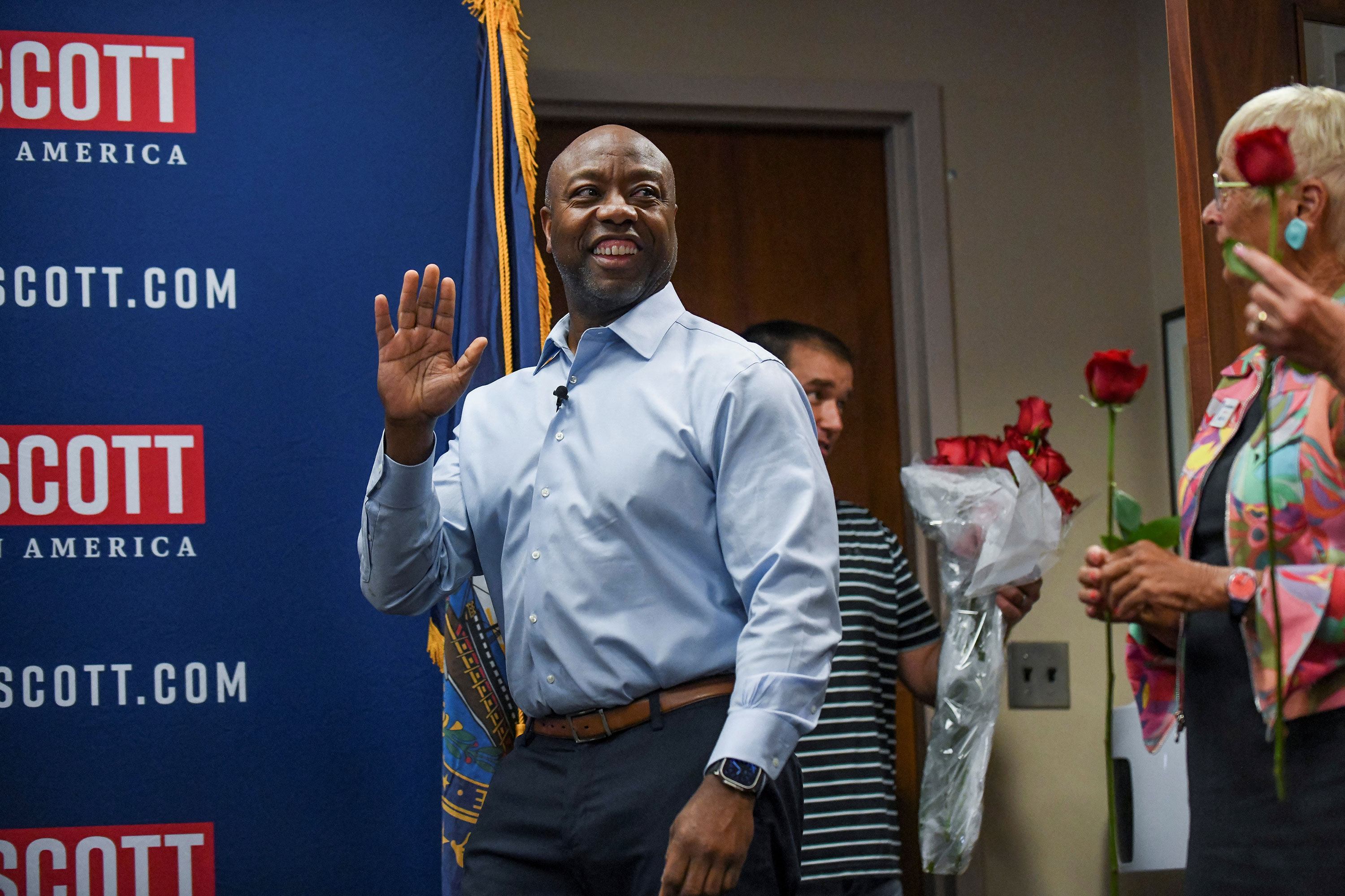 Republican Sen. Tim Scott of South Carolina waves to members of the New Hampshire Federation of Republican Women at Saint Anselm College's New Hampshire Institute of Politics in Manchester, New Hampshire, on May 25. 