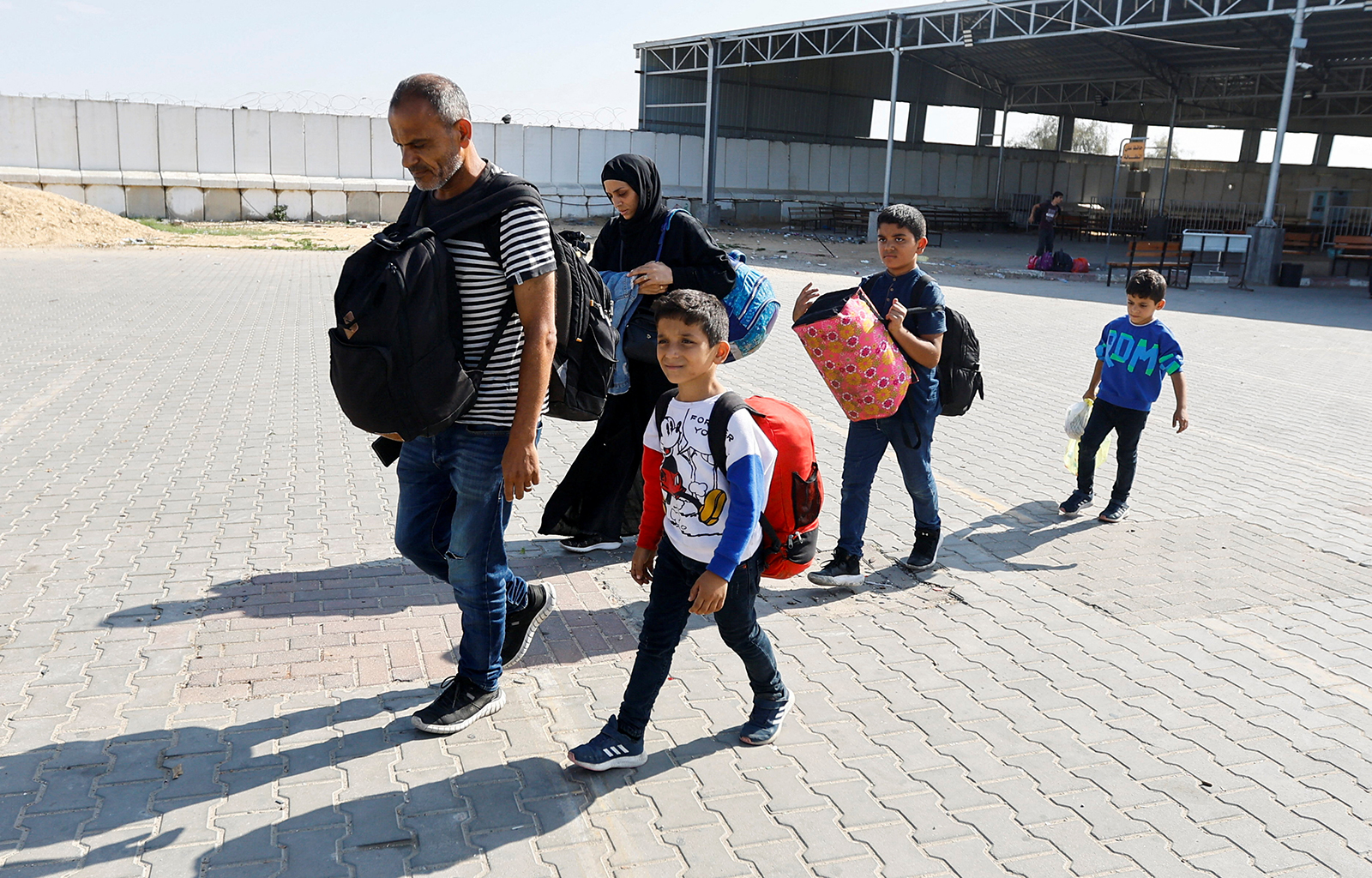 A family carries their luggage at the Rafah border crossing in Rafah, Gaza, on November 5. 