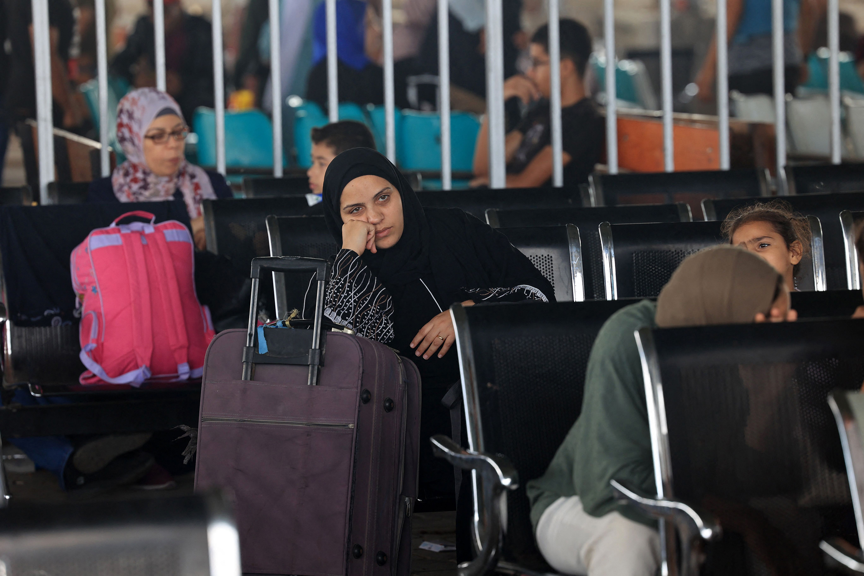 Civilians leaving Gaza wait as dual national Palestinians and foreigners prepare to cross the Rafah border point with Egypt, in the southern Gaza Strip, on November 2.