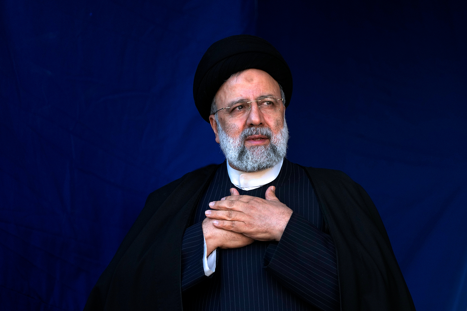 Iranian President Ebrahim Raisi places his hands on his heart as a gesture of respect to the crowd during a funeral ceremony in Tehran, Iran, on January 5, 2024.