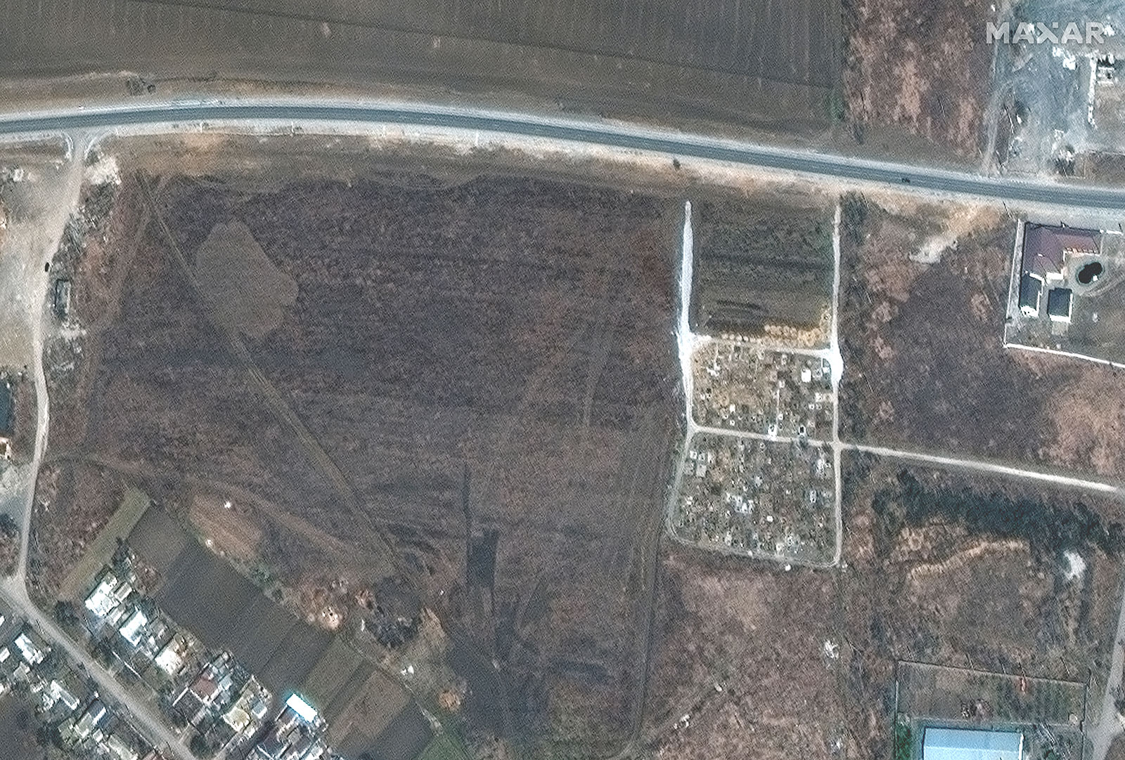 An overview of a cemetery and expansion of graves is seen on March 23.