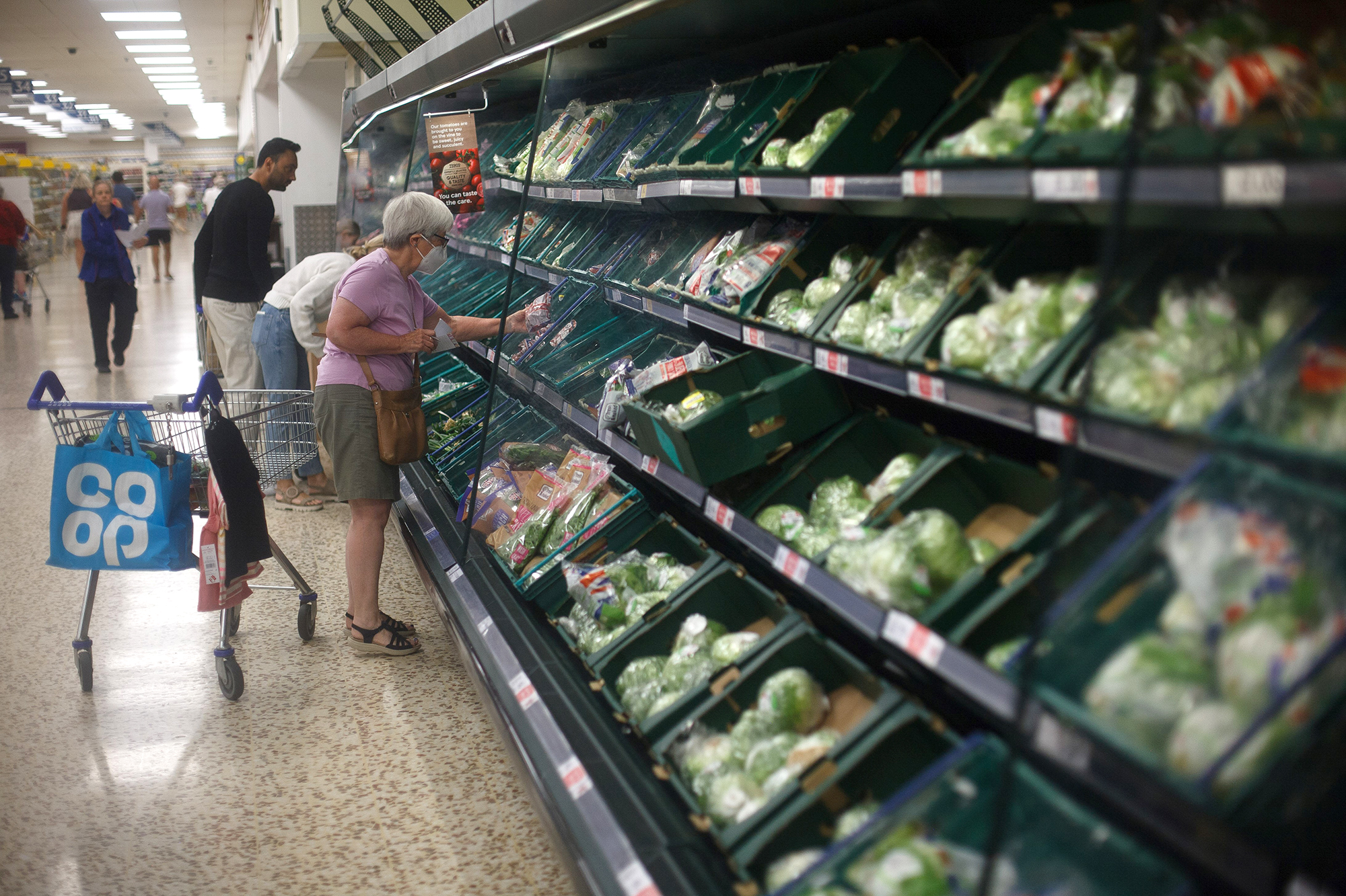 People purchase goods at a supermarket in Reading, Britain on August 21.