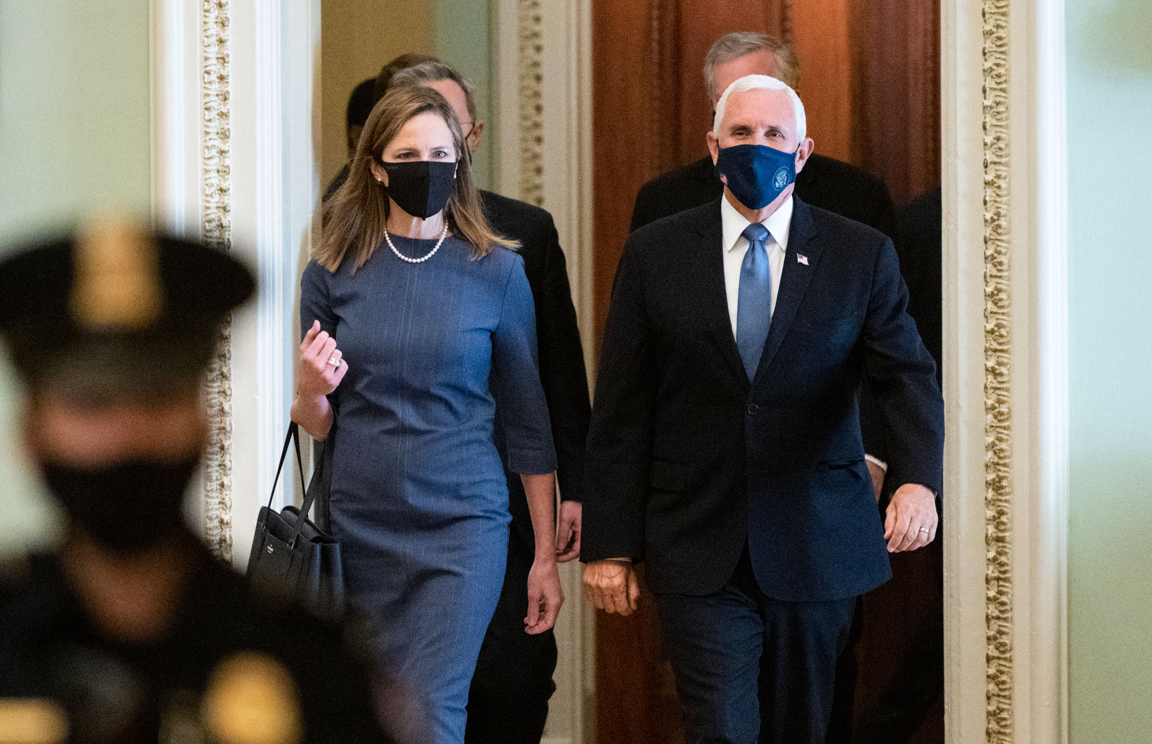 Supreme Court nominee Amy Coney Barrett, left, and Vice President Mike Pence walk through the Capitol on September 29.