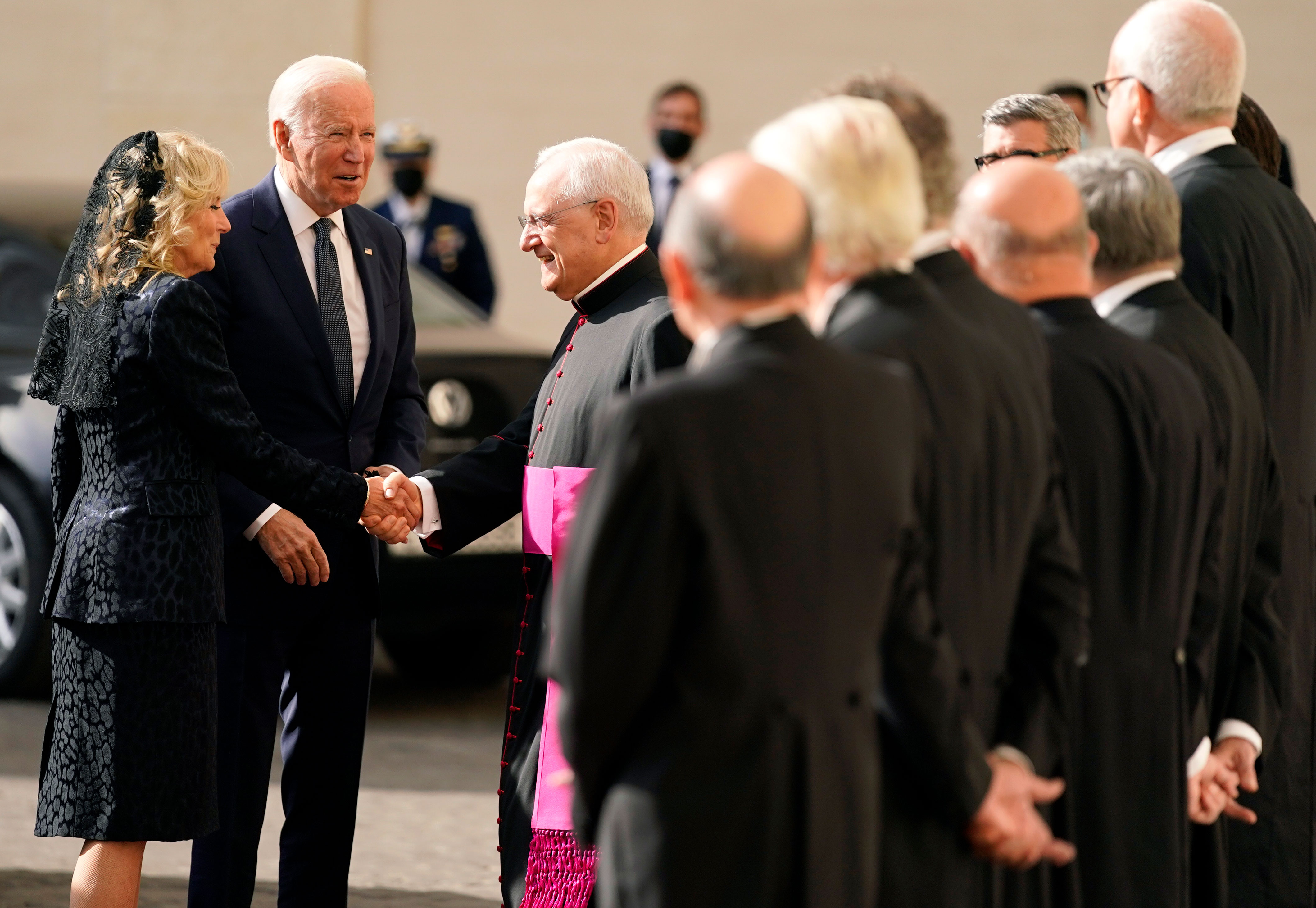 President Joe Biden and first lady Jill Biden are greeted by the Head of the Papal Household, Mons. Leonardo Sapienza, center, as they arrive for a meeting with Pope Francis at the Vatican on October 29.