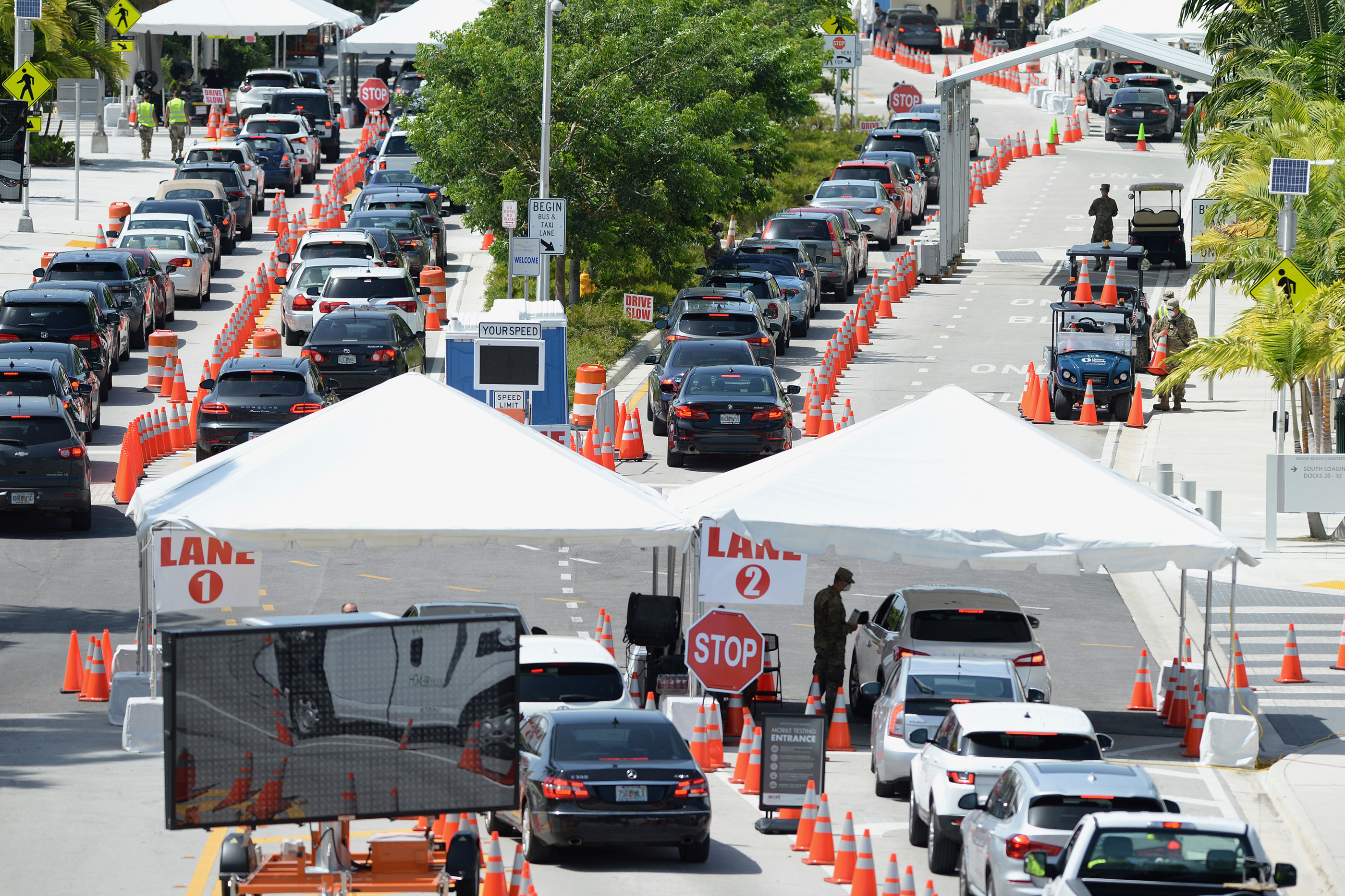 Cars wait in line at a drive-thru coronavirus testing site on July 2 in Miami Beach, Florida.