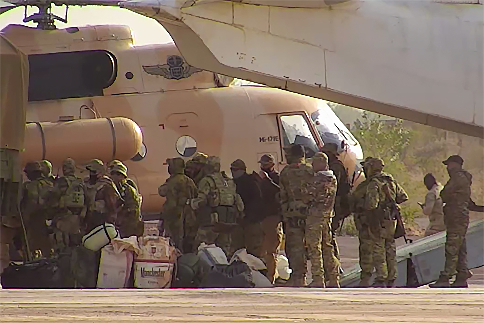 This undated photograph handed out by French military shows Russian mercenaries boarding a helicopter in northern Mali.
