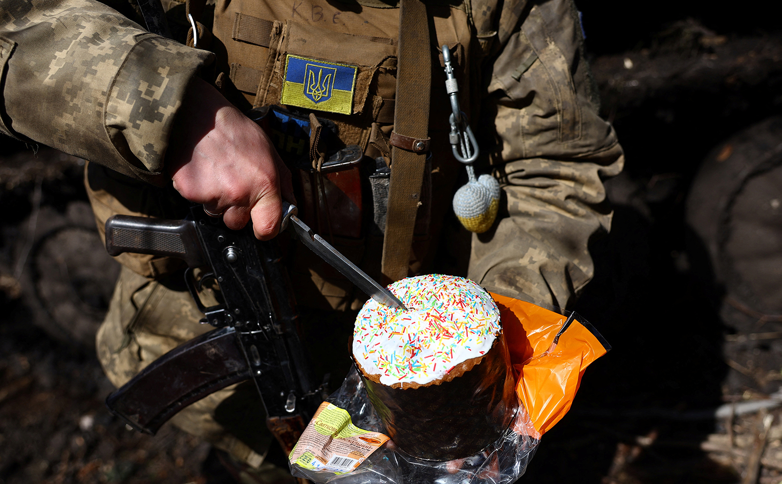 A Ukrainian soldier cuts an Easter cake near the frontline town of Bakhmut, Ukraine, on Sunday. 
