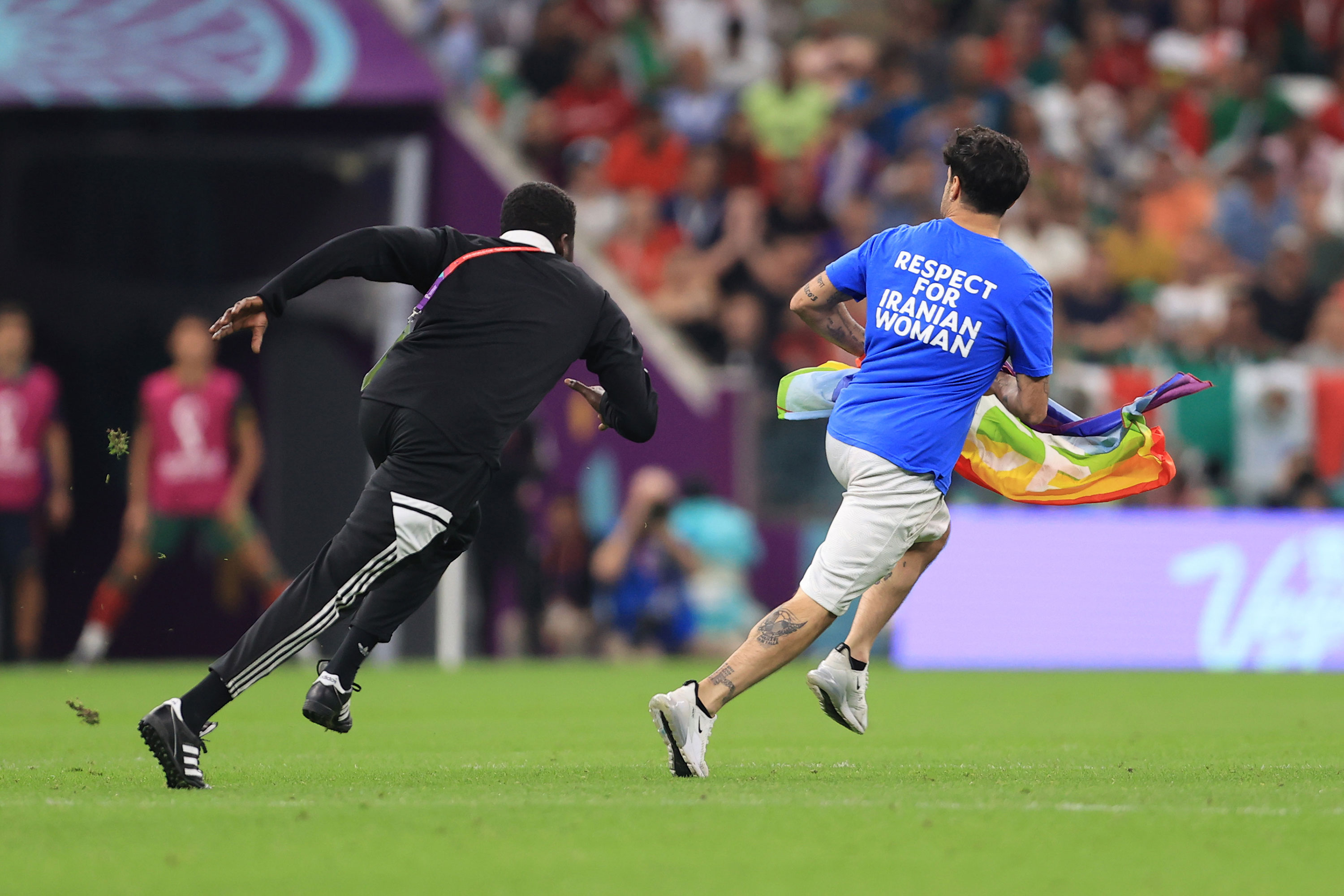 A pitch invader runs on the field during the match between Portugal and Uruguay on Monday.