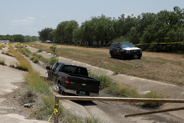 A police vehicle is seen parked near the truck believed to belong to the shooting suspect.