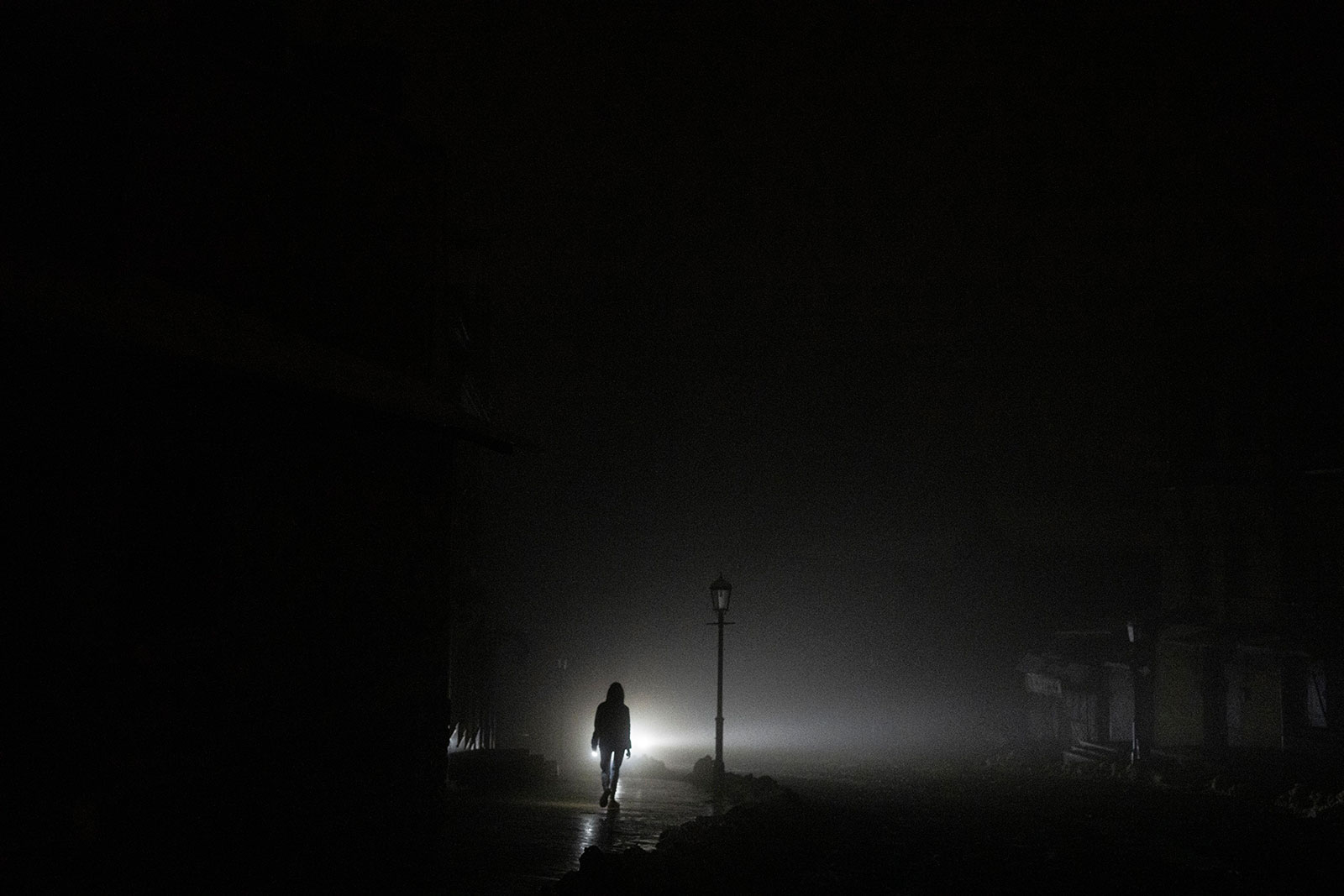 A woman walks through the city center in Kyiv which lost electrical power on November 24. 