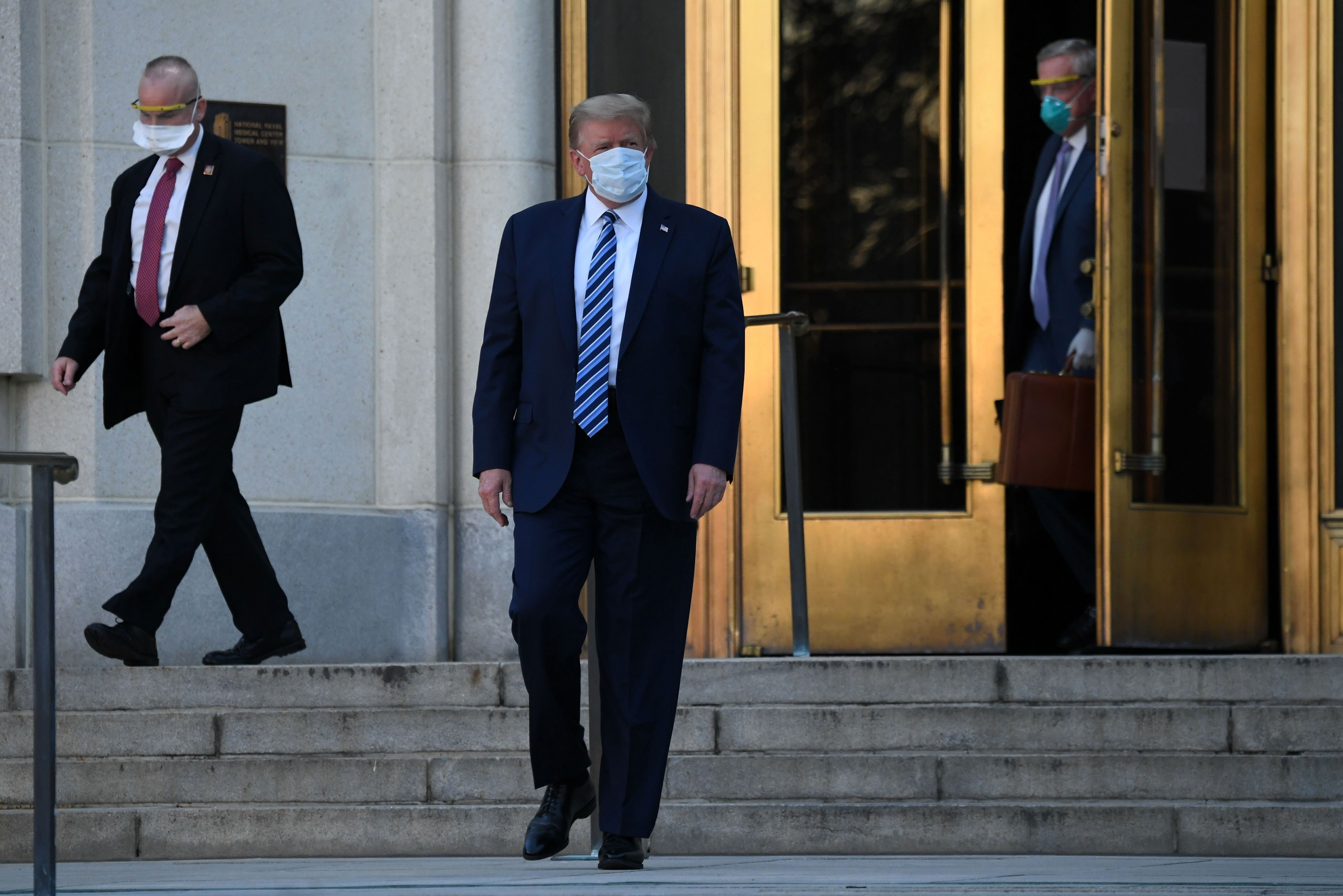 President Donald Trump, center, leaves Walter Reed medical center in Bethesda, Maryland, on October 5.