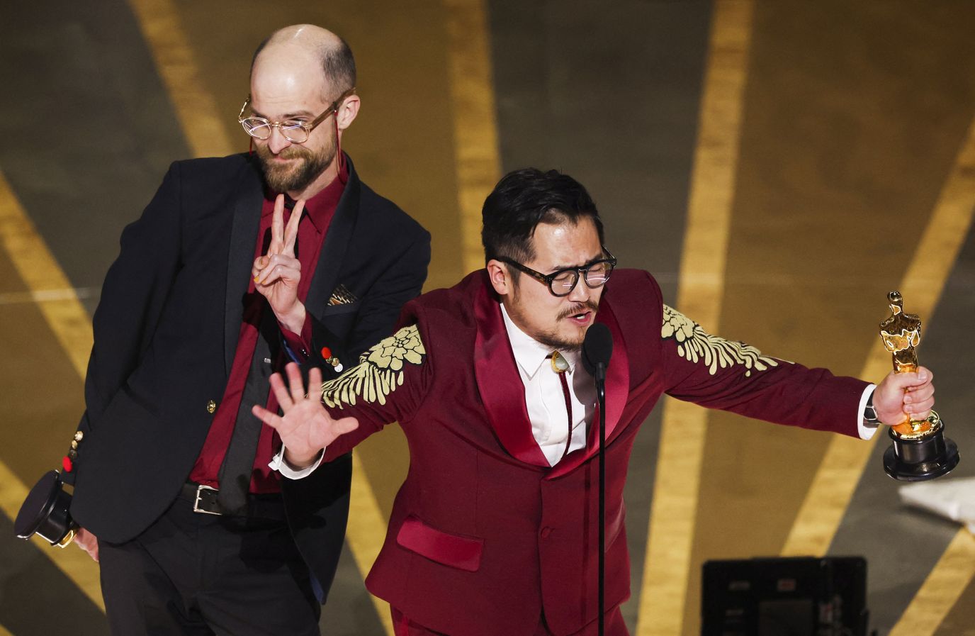 Daniel Scheinert, left, and Daniel Kwan accept the award for best original screenplay for "Everything Everywhere All At Once". 