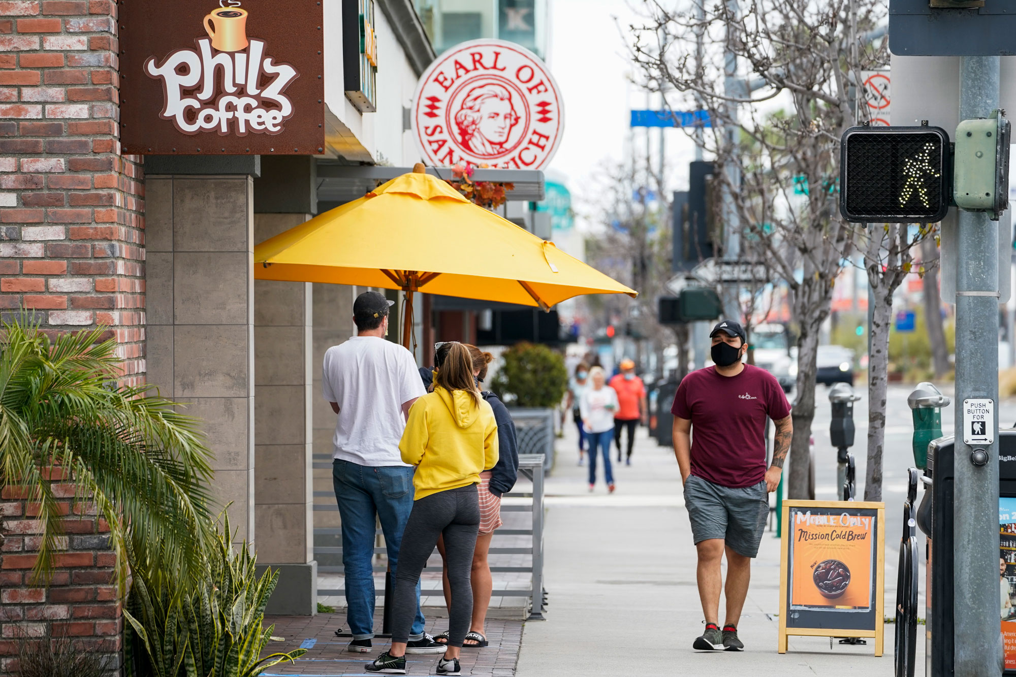 Customers wait in line at Philz Coffee on May 12 in Long Beach, California.