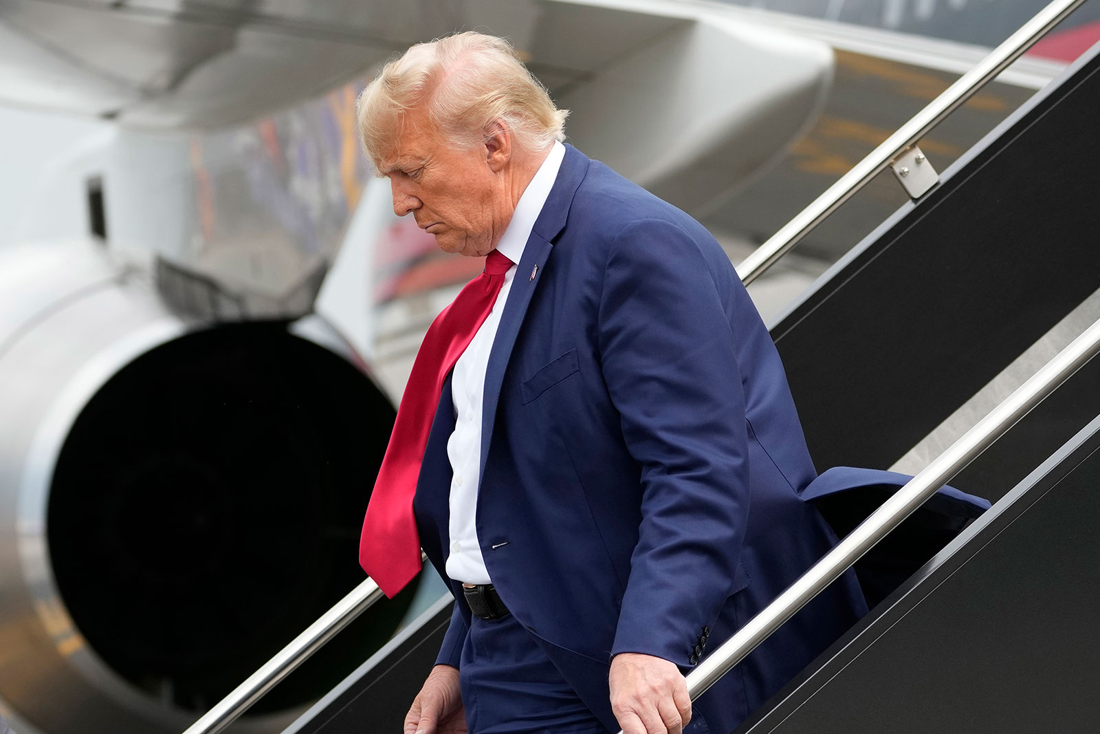 Former President Donald Trump arrives at Ronald Reagan Washington National Airport, Thursday, August 3, in Arlington, Virginia.