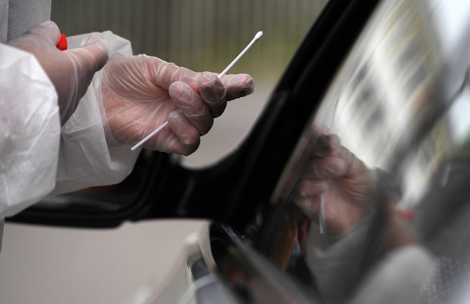 A member of medical staff holds a nasal swab as he collects samples from a person at a Covid-19 drive-in test in Brest, France, on Wednesday, July 31. 