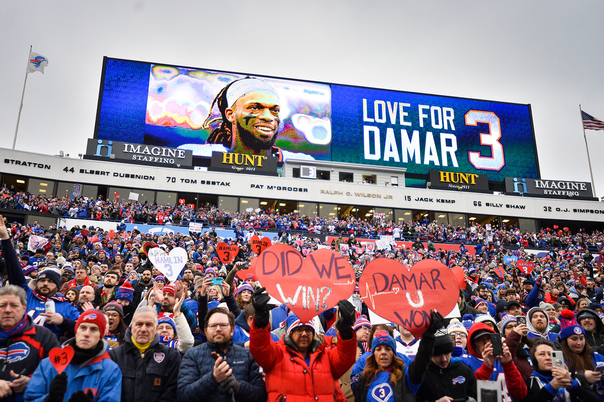 Fans hold signs in support of Hamlin ahead of the Bills game on Sunday. 