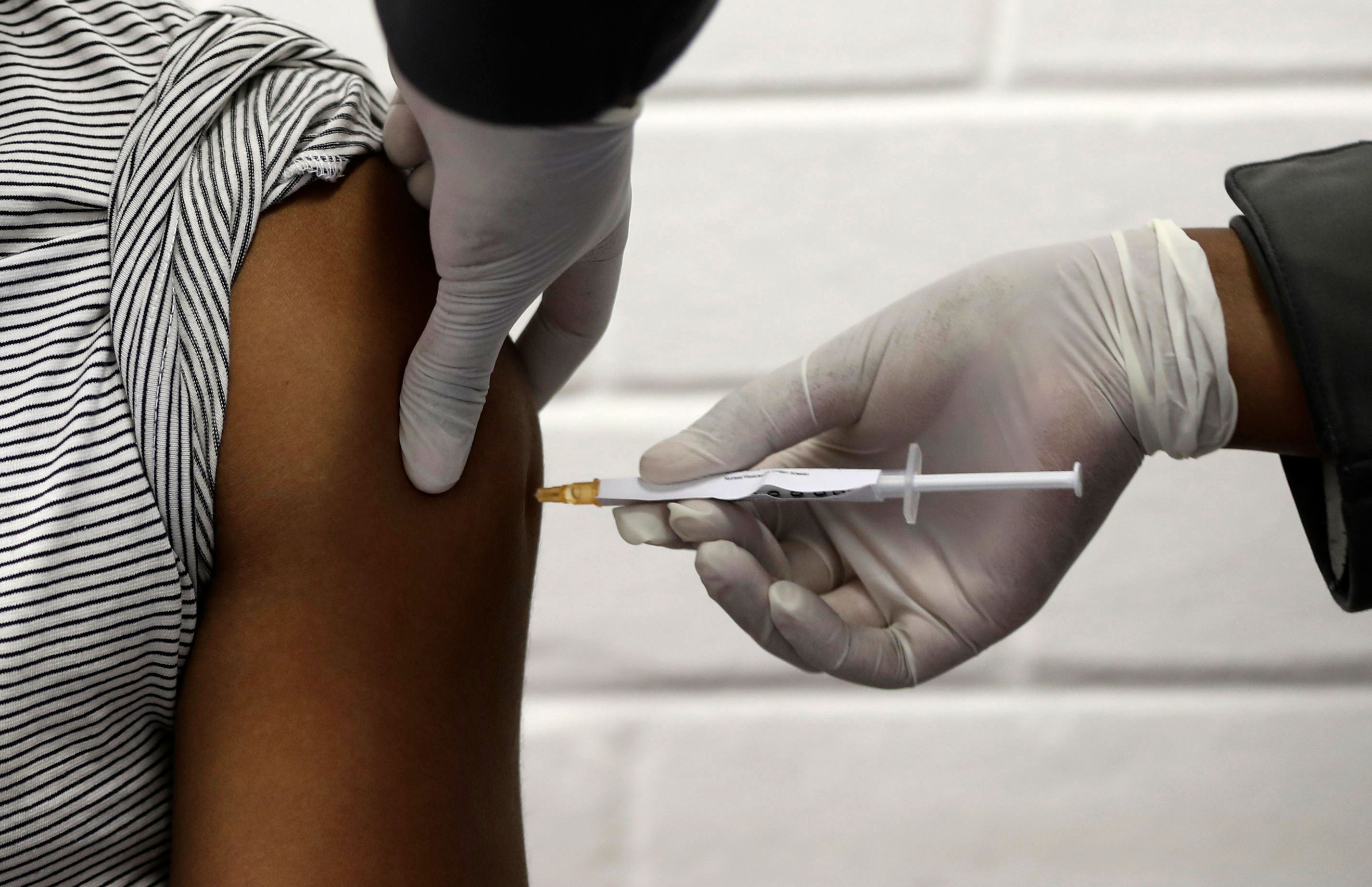 A volunteer receives an injection at a hospital in Soweto, South Africa, on June 24, 2020, as part of Africa's first participation in a Covid-19 vaccine trial developed by the University of Oxford and AstraZeneca.