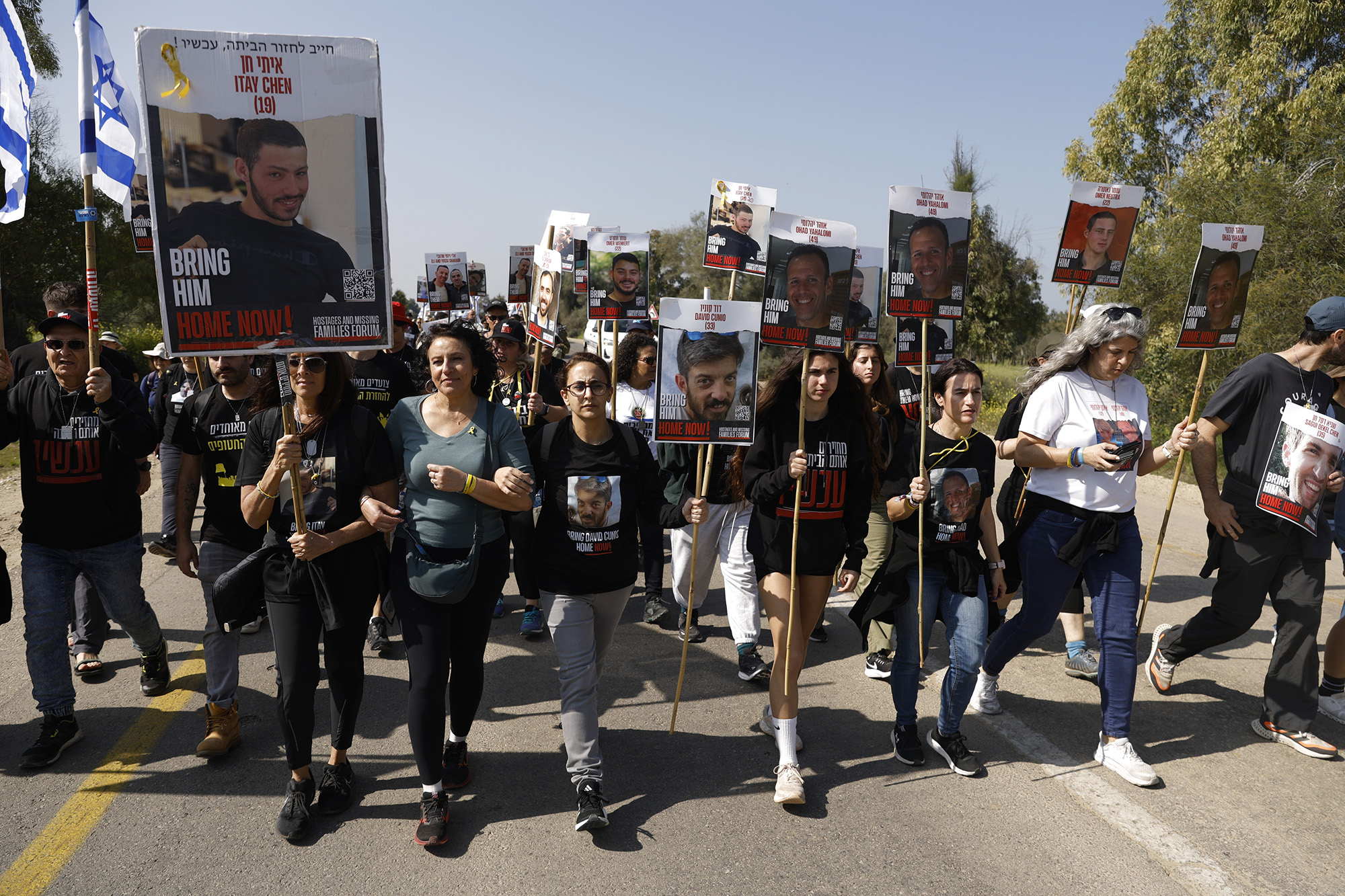 Families and supporters of Israeli hostages held in Gaza march with photos of hostages as they start a four-day protest march at the 'Nova' party site to Jerusalem on February 28, in Re'im, Israel. 