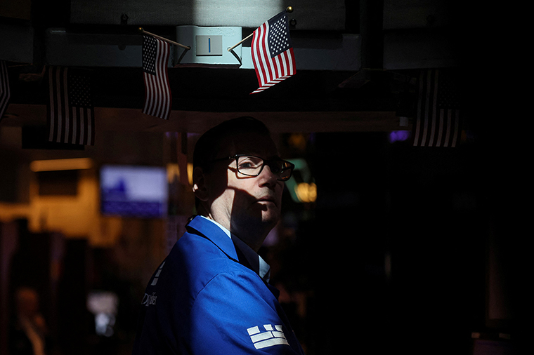 A specialist trader works inside a booth on the floor of the New York Stock Exchange on June 15.