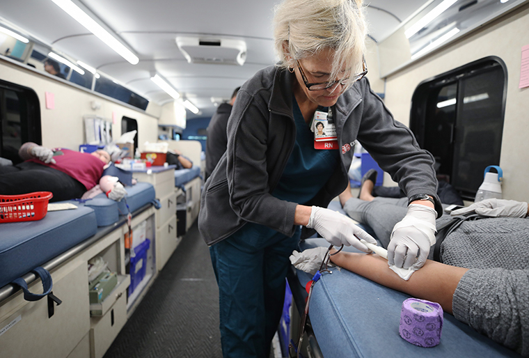 Cedars-Sinai charge nurse Lorraine McPherson works as employees donate blood during a blood drive held in a blood mobile outside Cedars-Sinai Medical Center on March 19,  in Los Angeles, California. 