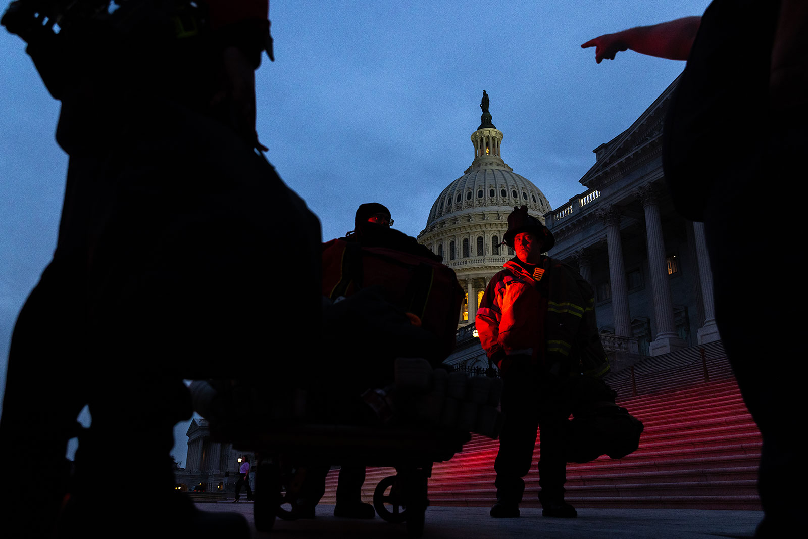 Firefighters unload equipment in front of the Capitol.
