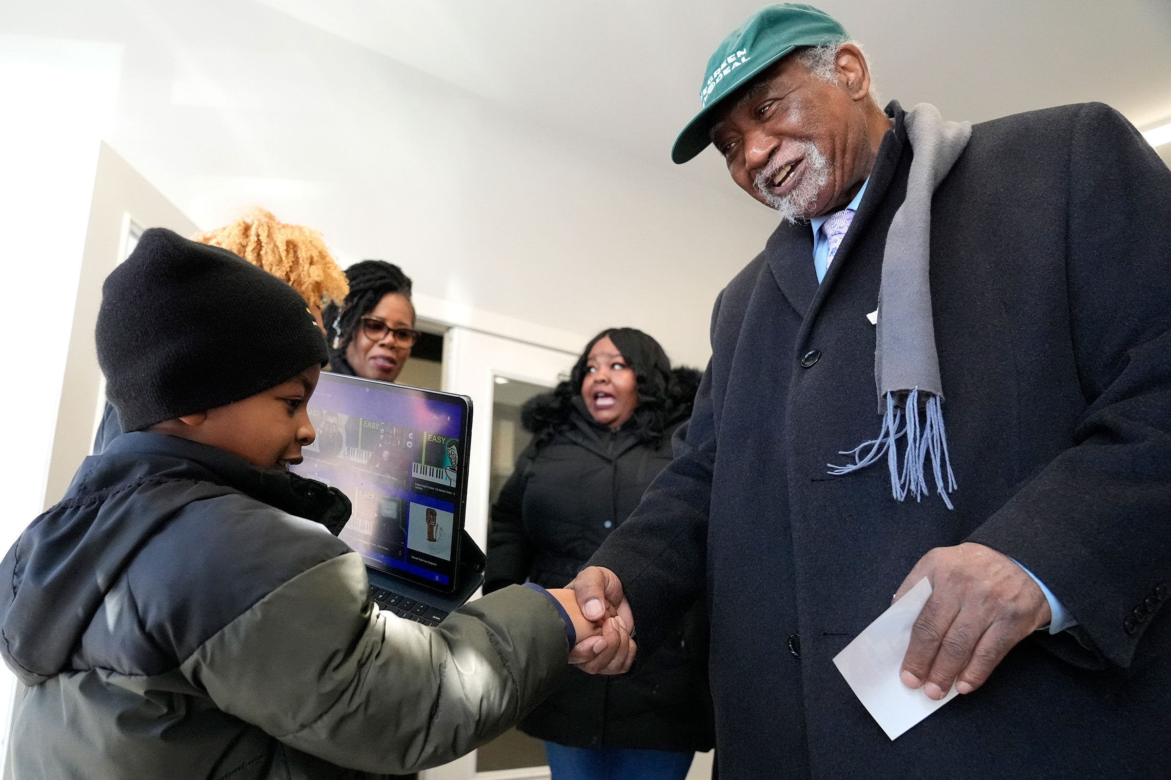Illinois Rep. Danny Davis greets Miles Durosinmi, 7, after voting at Sankofa Cultural Arts & Business center in Chicago, Tuesday, March 19.