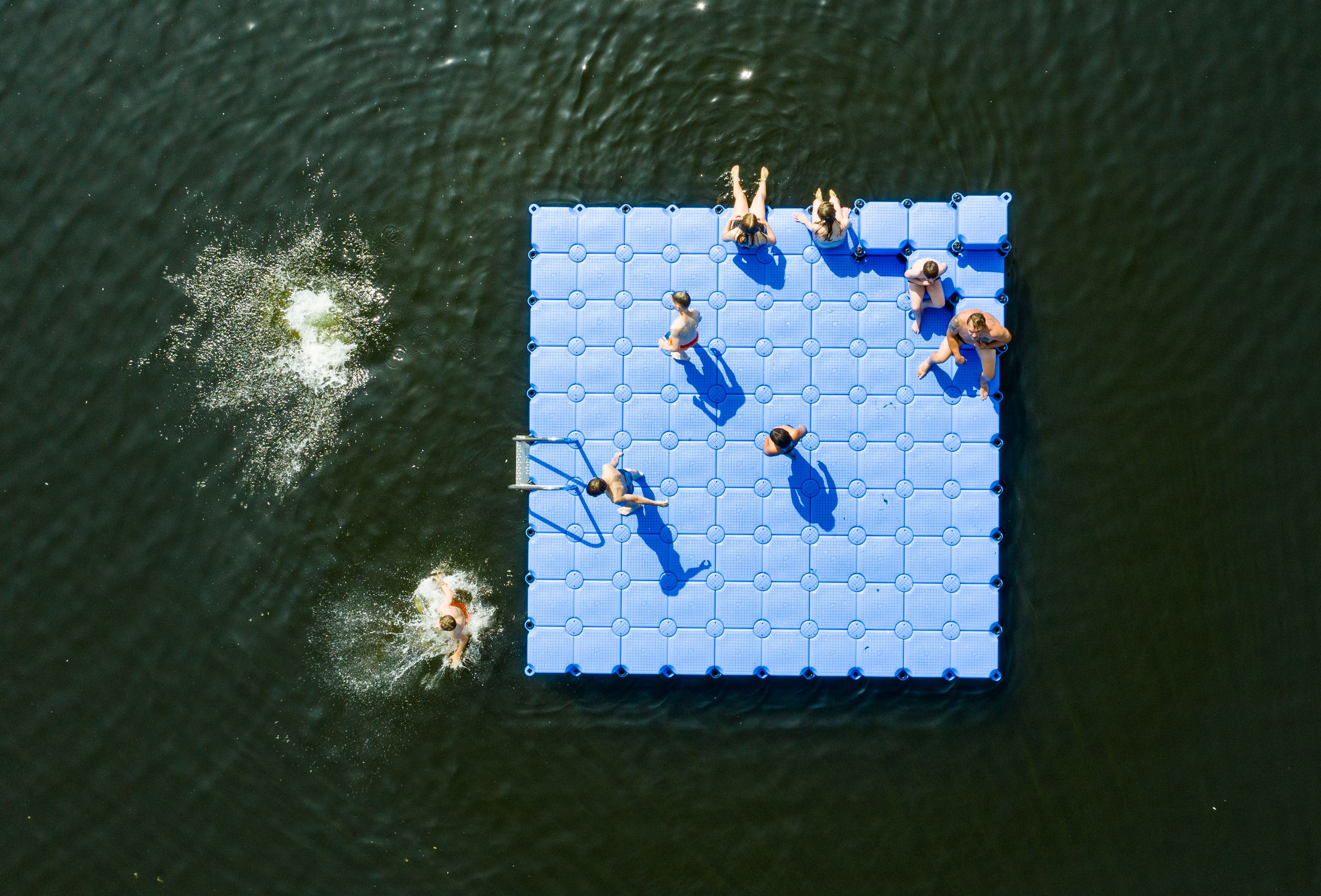 Swimmers sunbathe on a float on the Altwarmbuechener See lake in Hanover, northern Germany, where temperatures were predicted to reach 39 Celsius (102 degrees Fahrenheit). (Christophe Gateau/DPA/AFP)