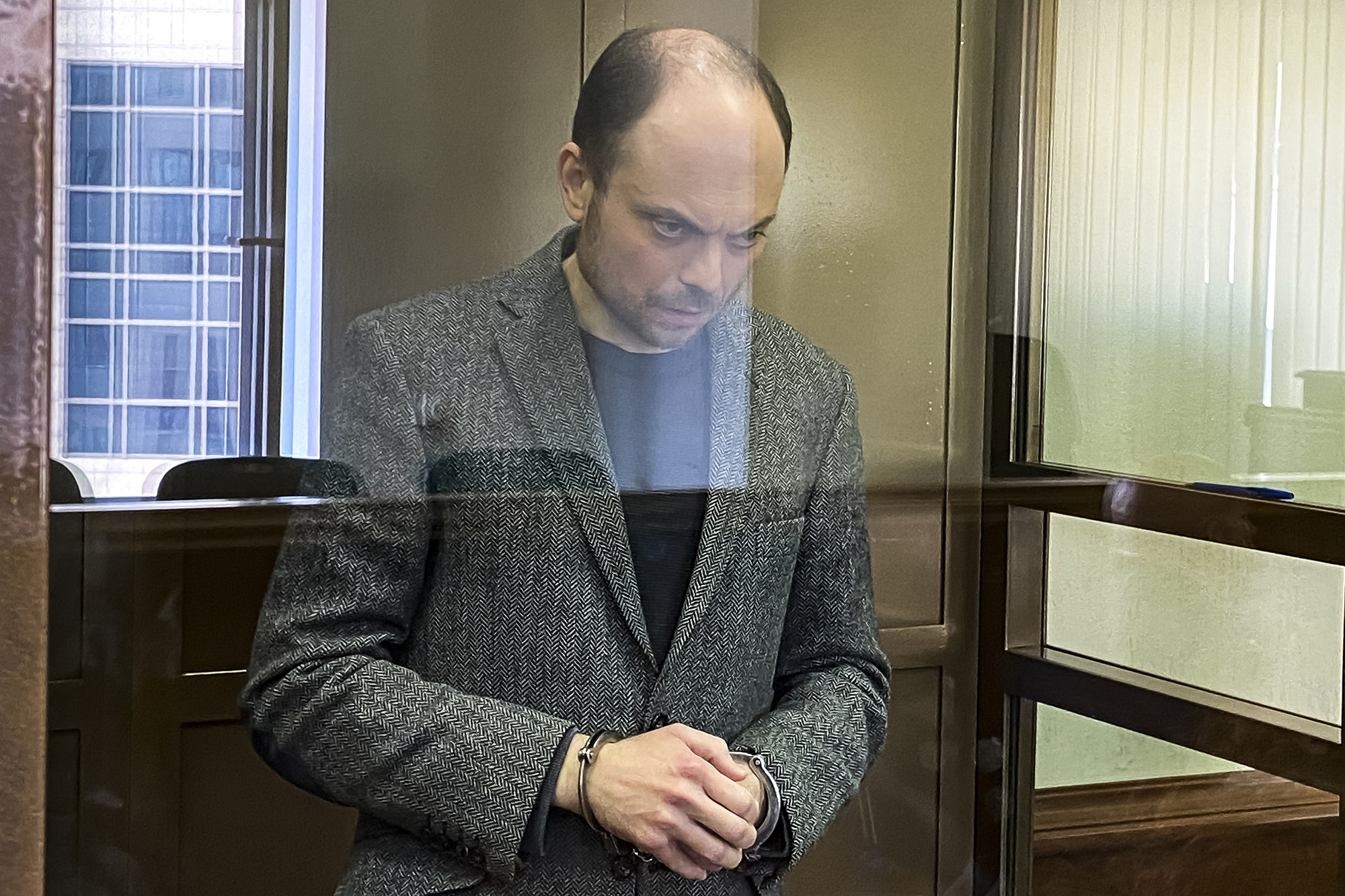 Russian opposition activist Vladimir Kara-Murza stands in a glass cage in a courtroom at the Moscow City Court in Moscow, Russia, on April 17.