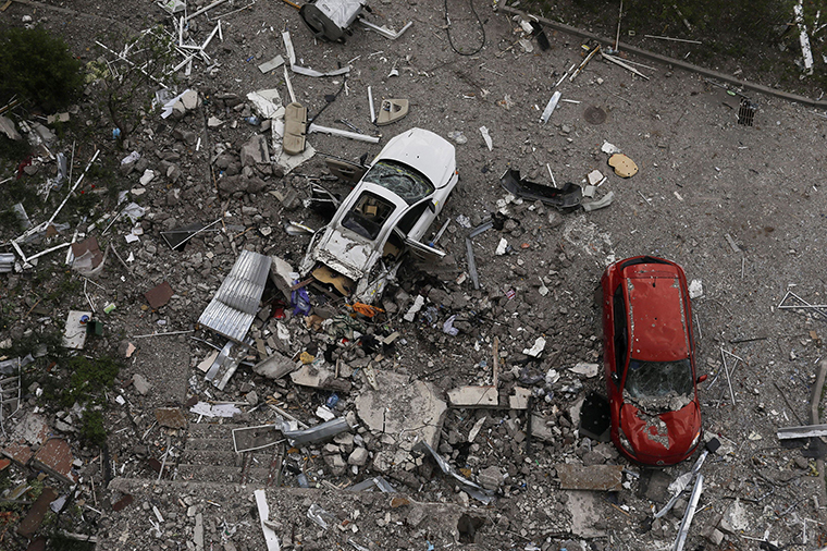 Damaged cars and debris from a damaged residential building are seen in the  Saltivka neighbourhood, of  Kharkiv, Ukraine, on Tuesday May 10. 