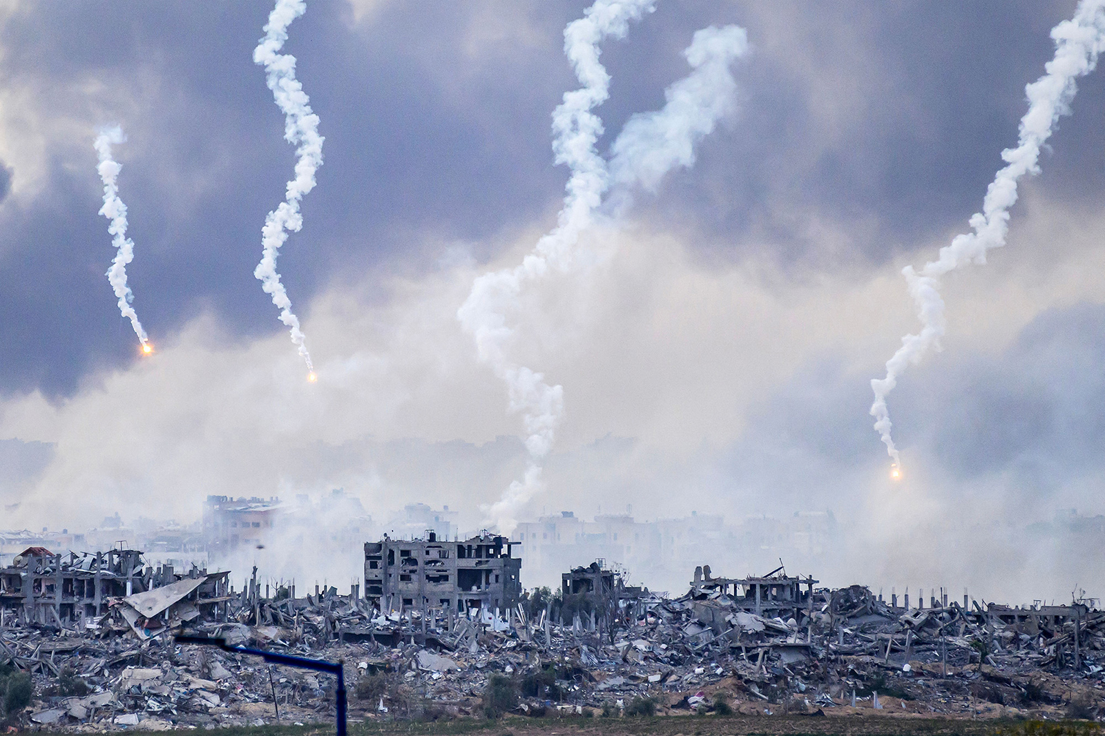 Smoke billows after an Israeli strike as flares are dropped over northern Gaza on November 22.