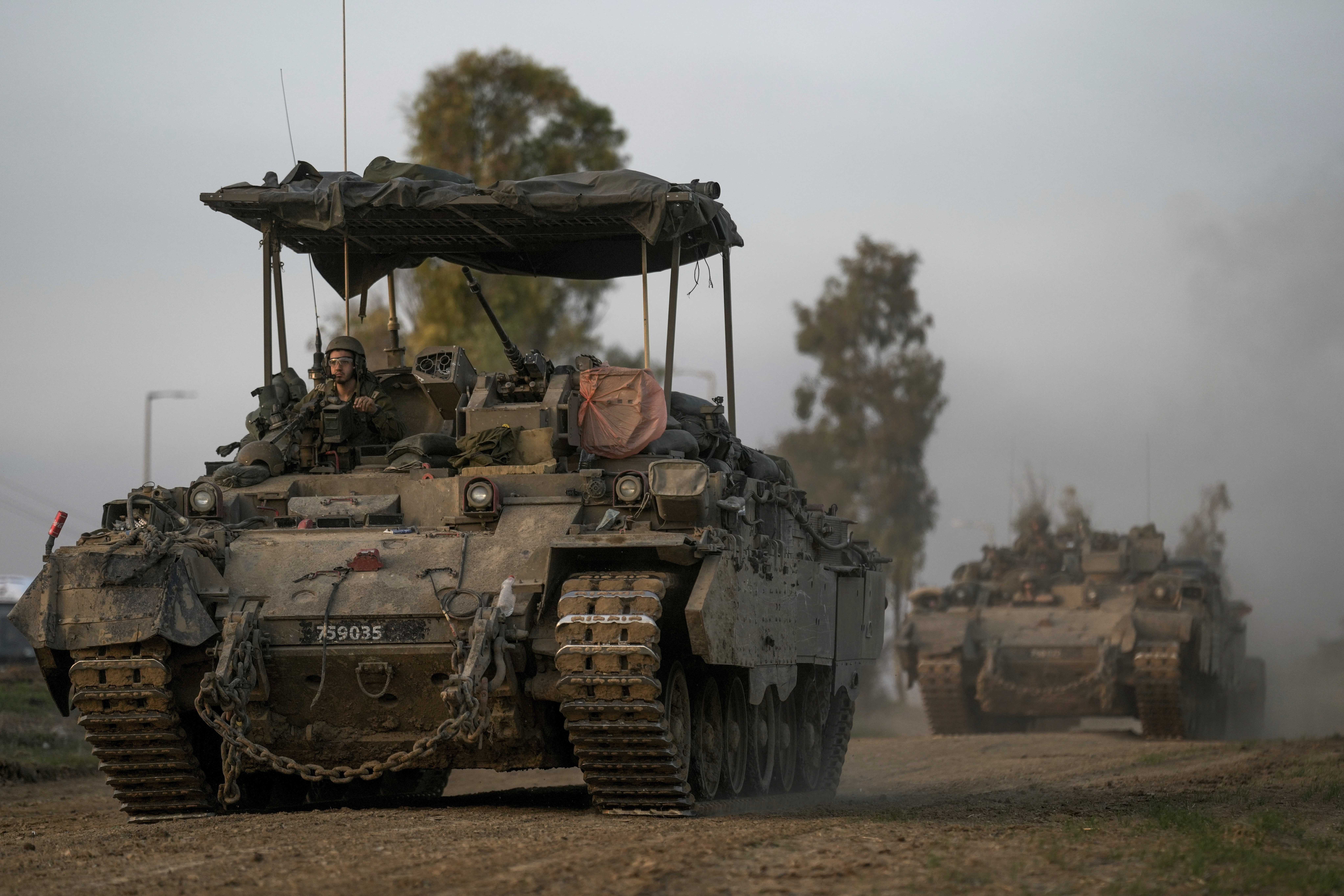 A Israeli army convoy moves near the Israel-Gaza border, in southern Israel, on December 25.